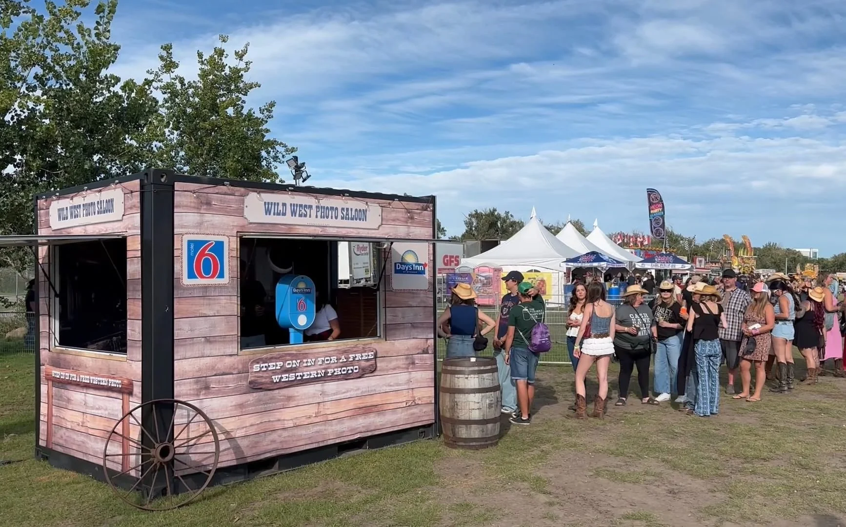 a saloon style photo booth setup at an outdoor music festival