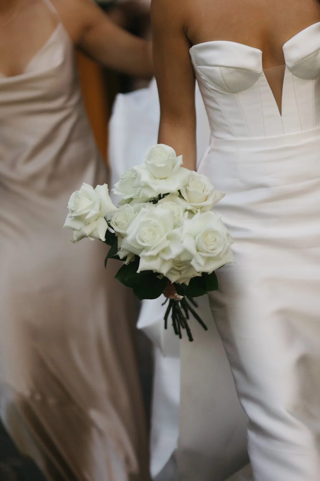 A bride holding a bouquet of white roses at her wedding.