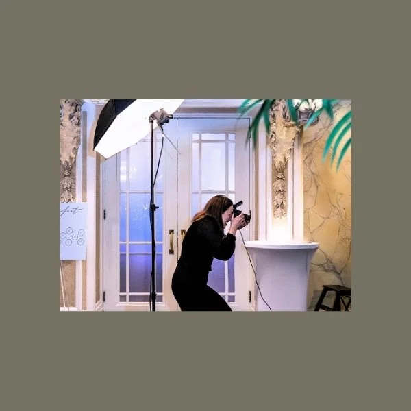 a photographer taking a photo in studio photo booth