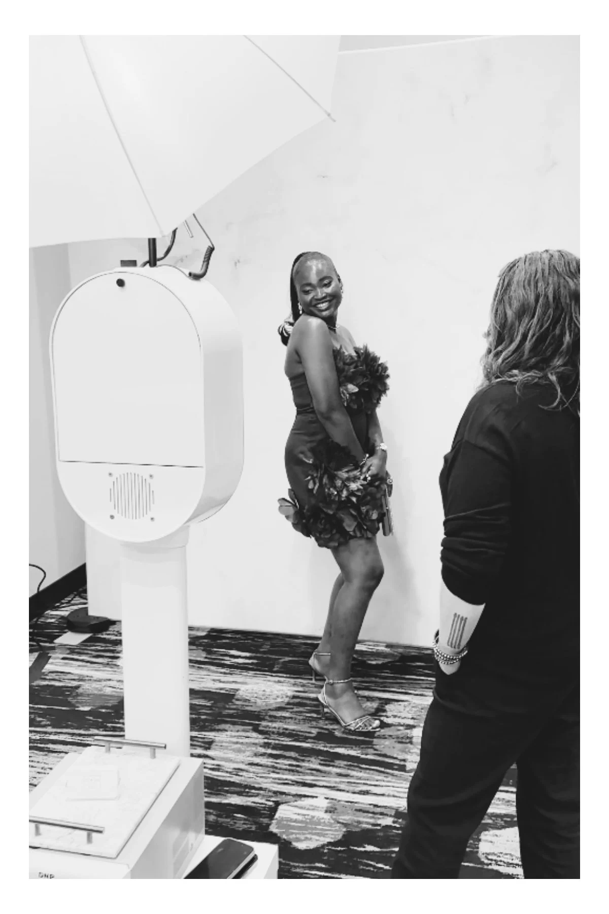 a women poses at a wedding reception in a glam photo booth