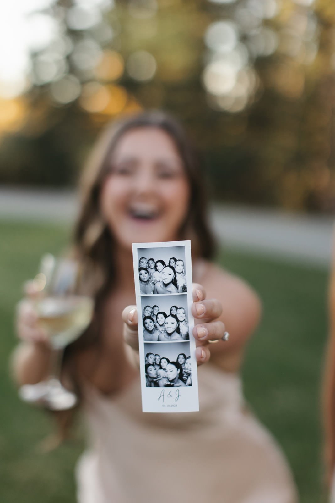 a wedding guests holds up a 2x6 photo strip from a vintage photo booth in calgary