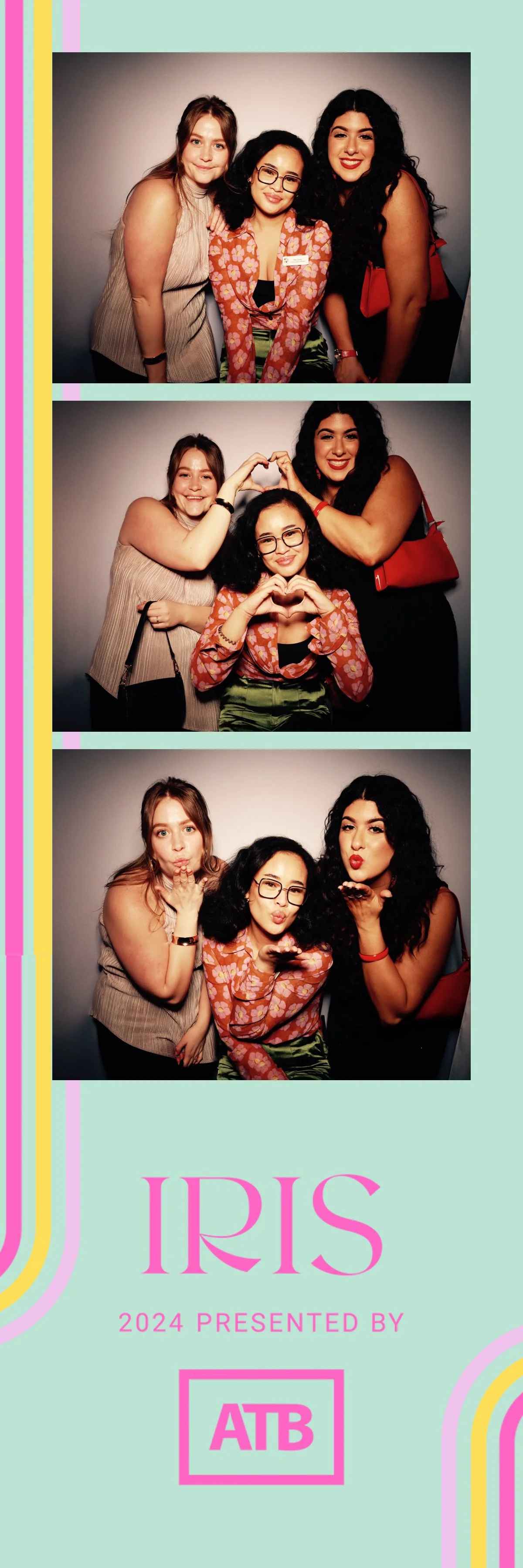 A photo booth strip with three pictures of three women posing and having fun. The women are smiling, making heart shapes with their hands, and blowing kisses. The strip features a pink and pastel color theme with "IRIS 2024 Presented by ATB" printed 
