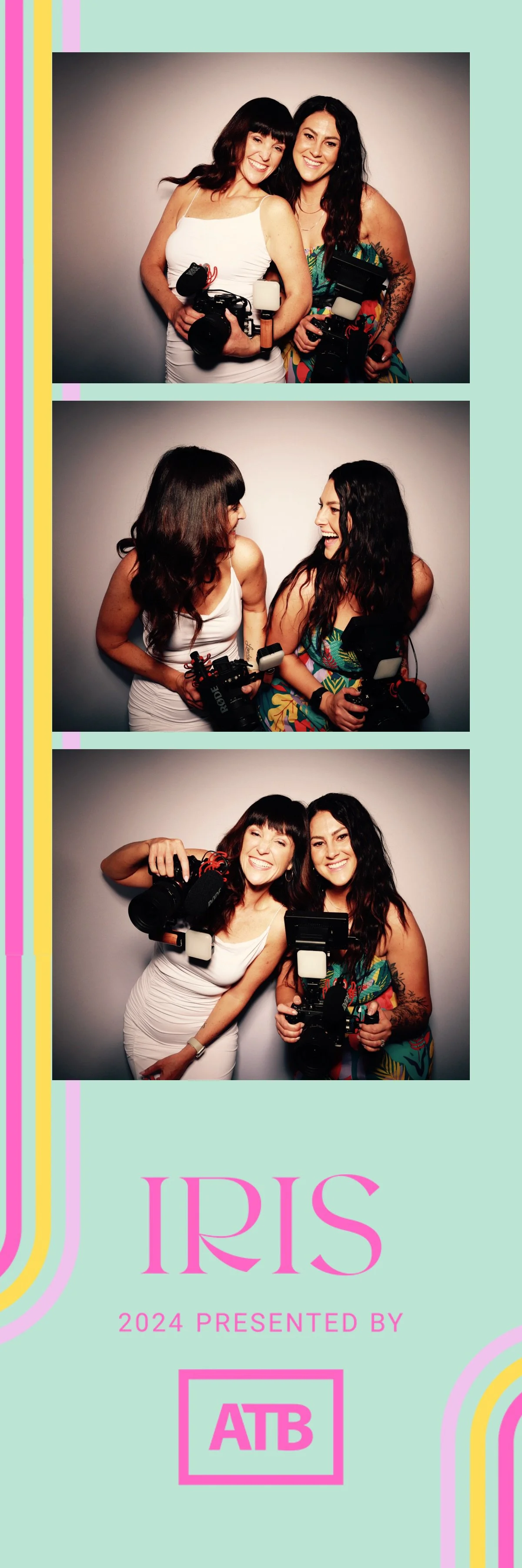 Three women holding professional photography equipment, smiling and posing together in a photo booth with an IRIS event banner at the bottom.