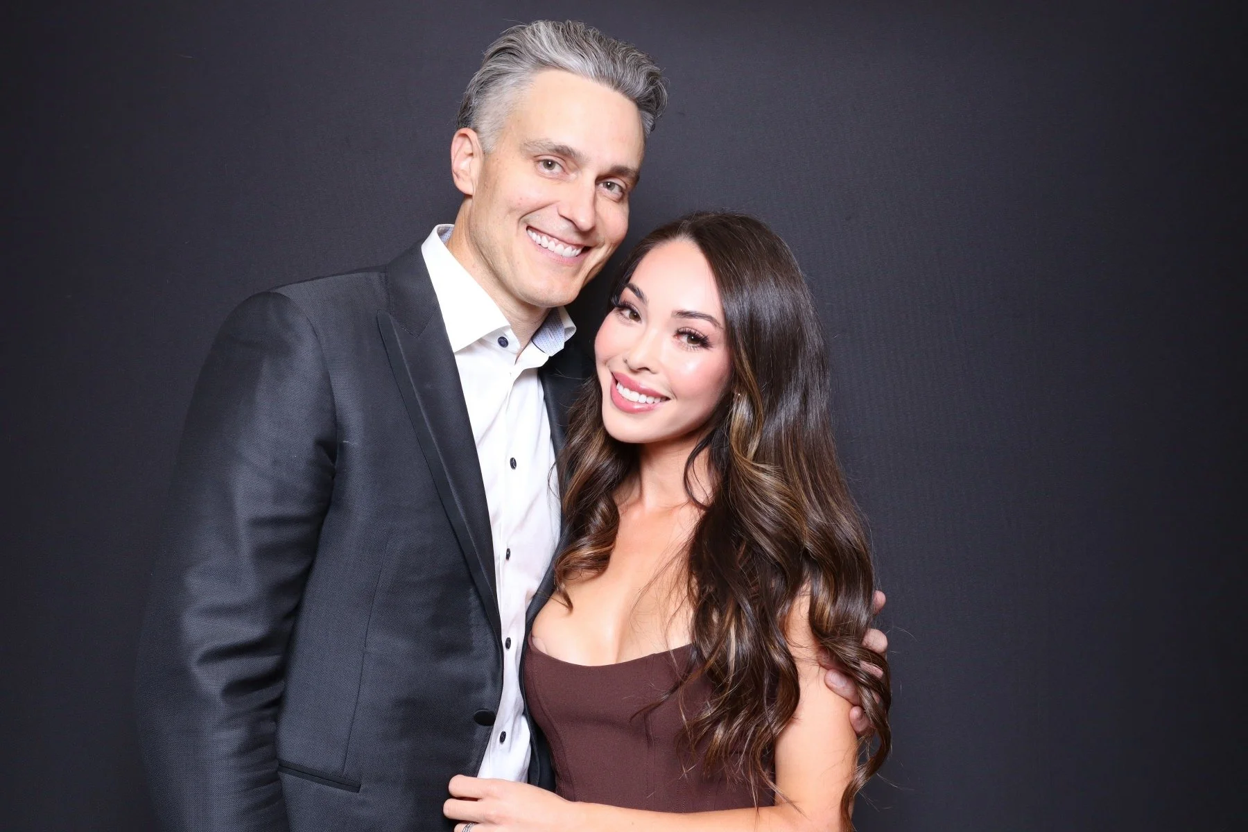 wedding guests pose for photos in a photo booth