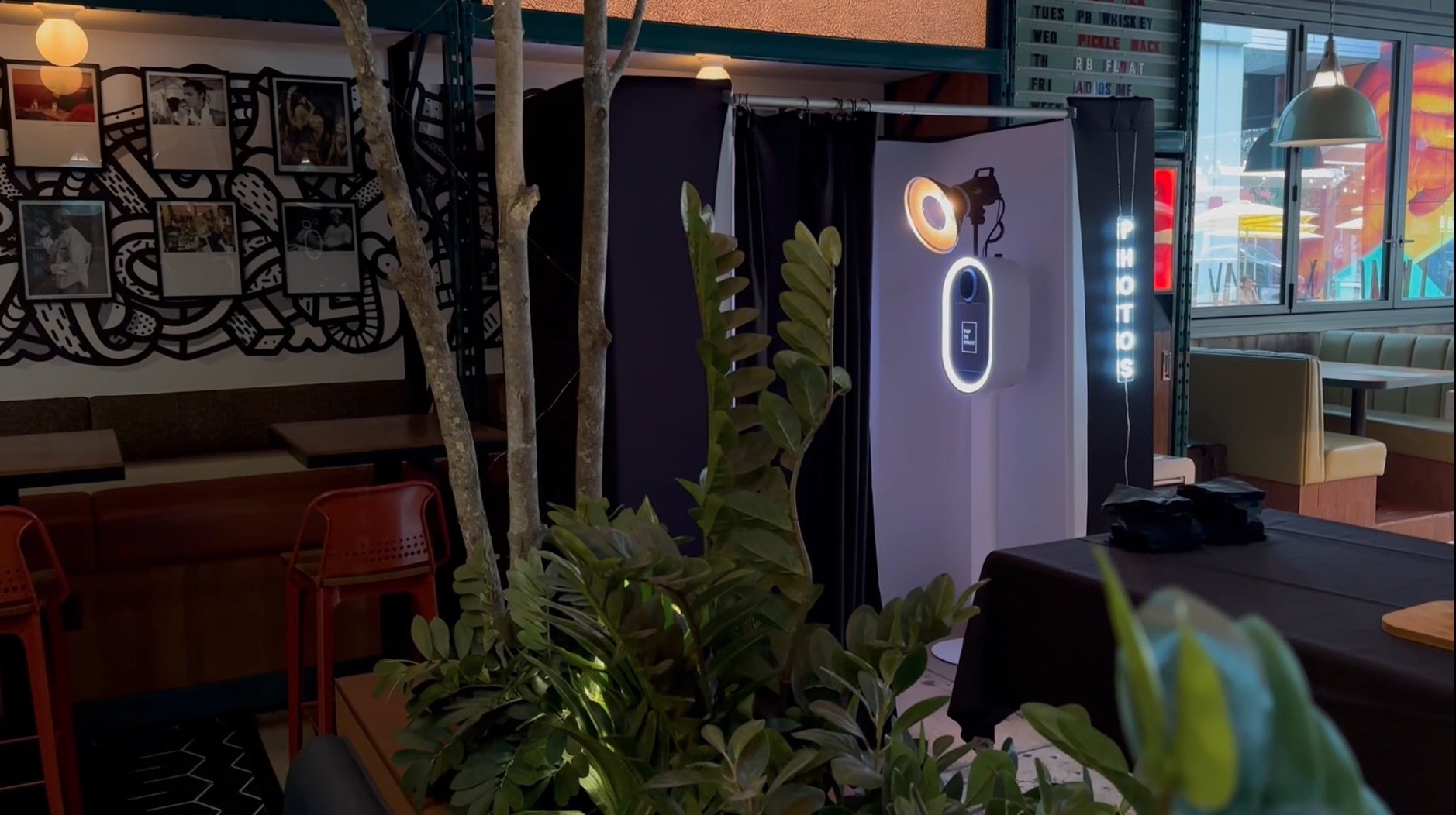 a vintage style photo booth enclosure with open curtain and beauty dish lighting