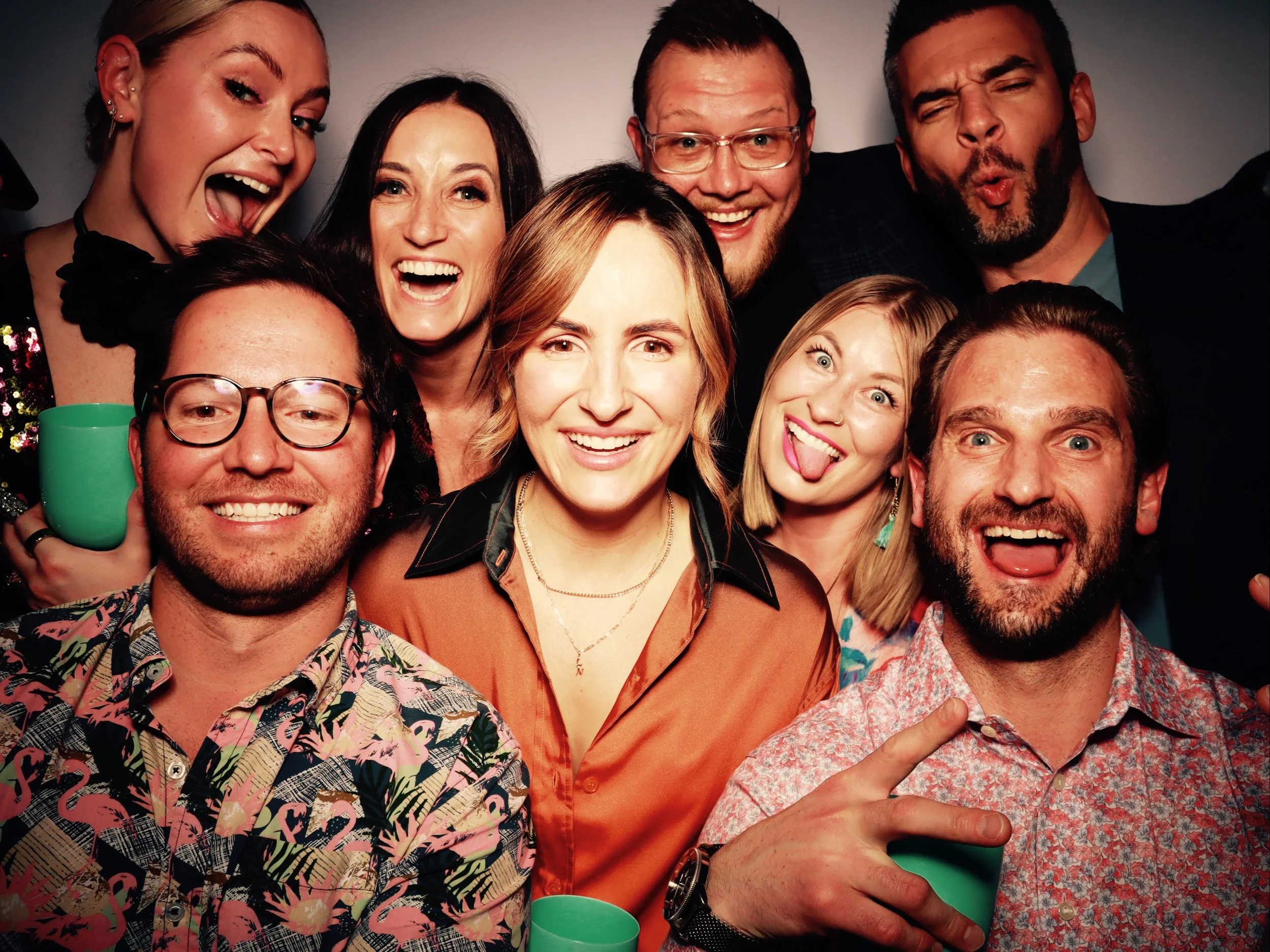 Group of friends celebrating, smiling, and having fun at a party.