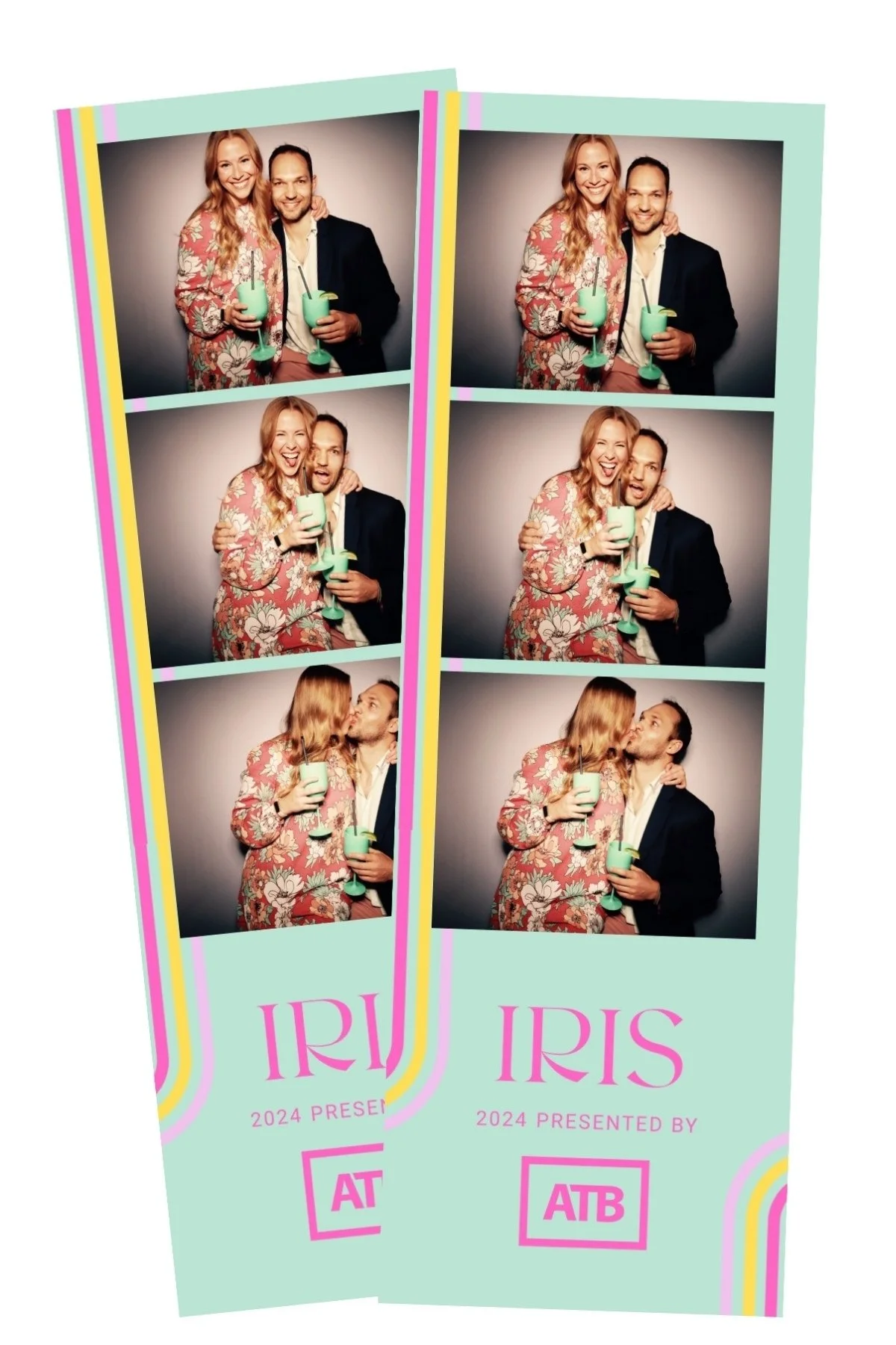 Two people in floral and dark suits in a photo booth taking playful photos with drinks and kisses, with a pink and pastel-colored event banner that reads 'IRIS 2024 Presented by ATB'.
