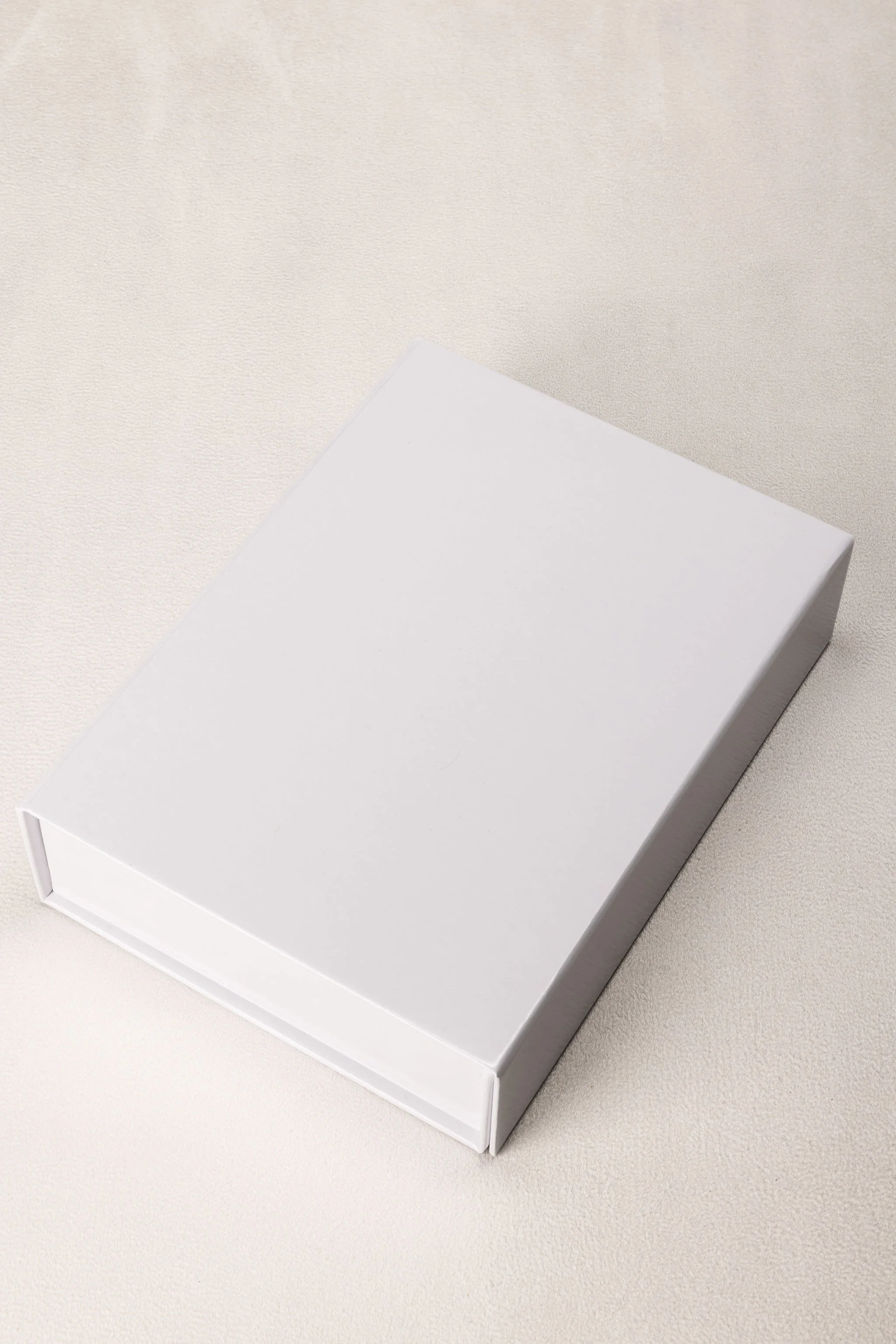 A plain white rectangular box on a light-colored surface.
