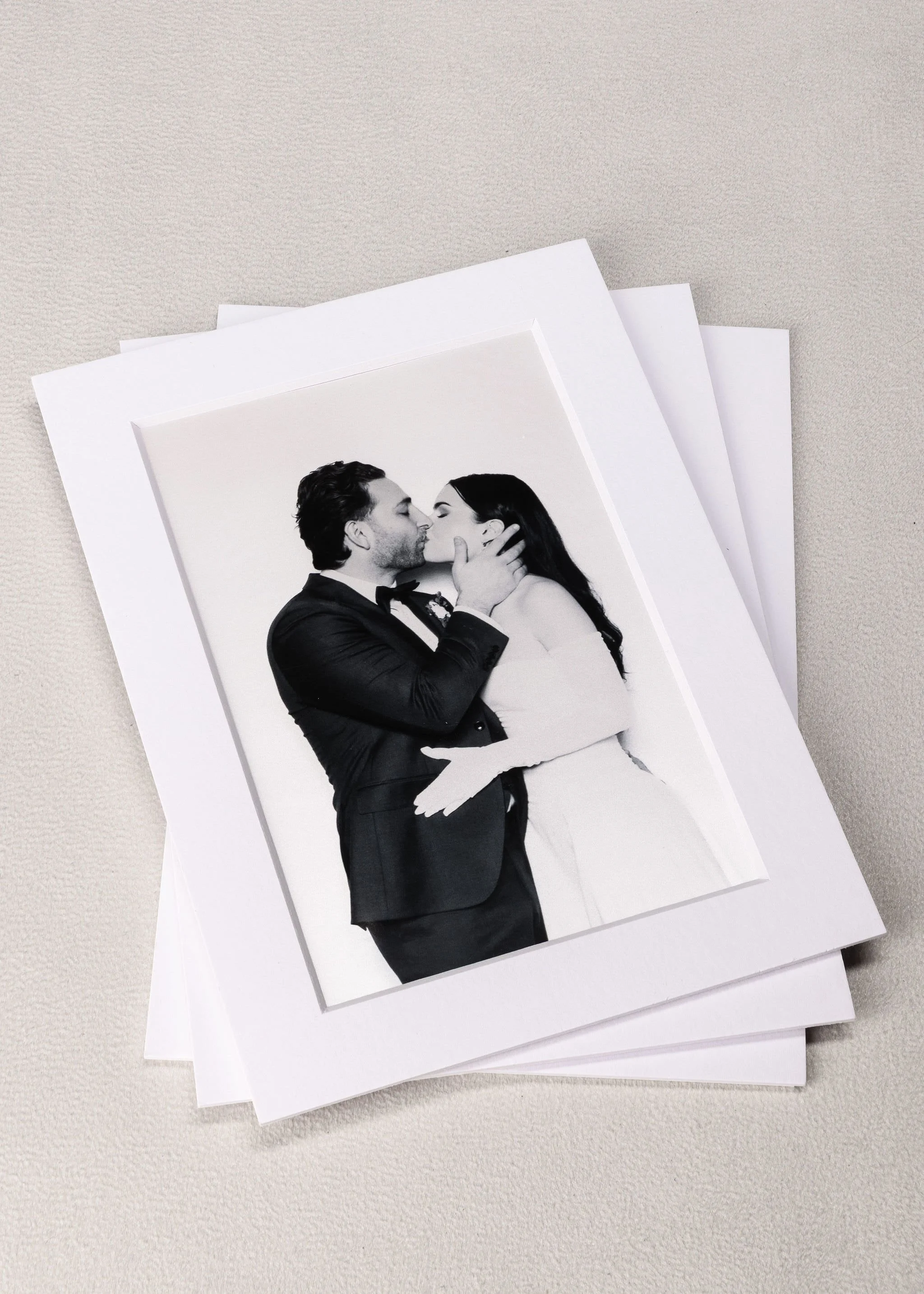Black and white photograph of a man and woman kissing.