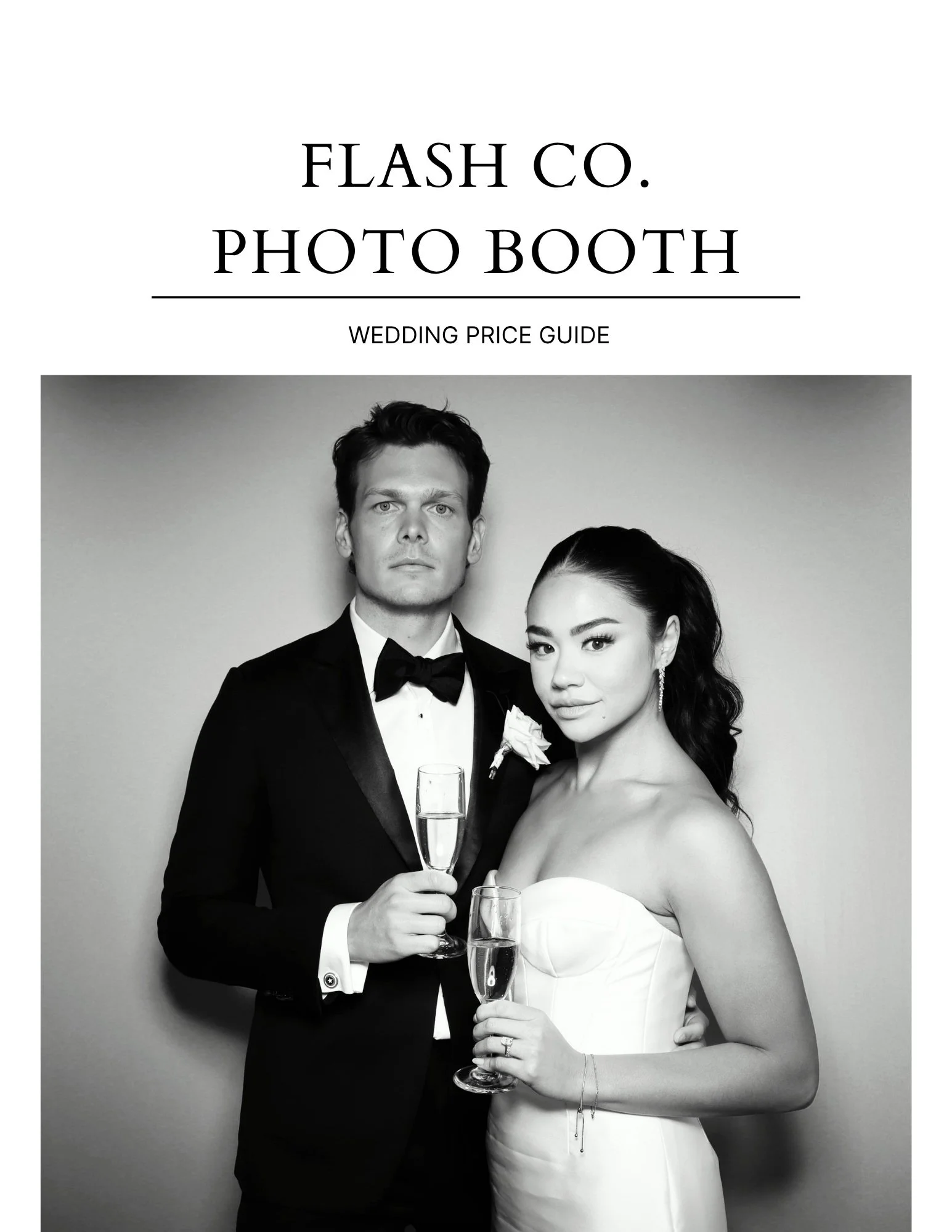 a wedding couple poses in a photo booth