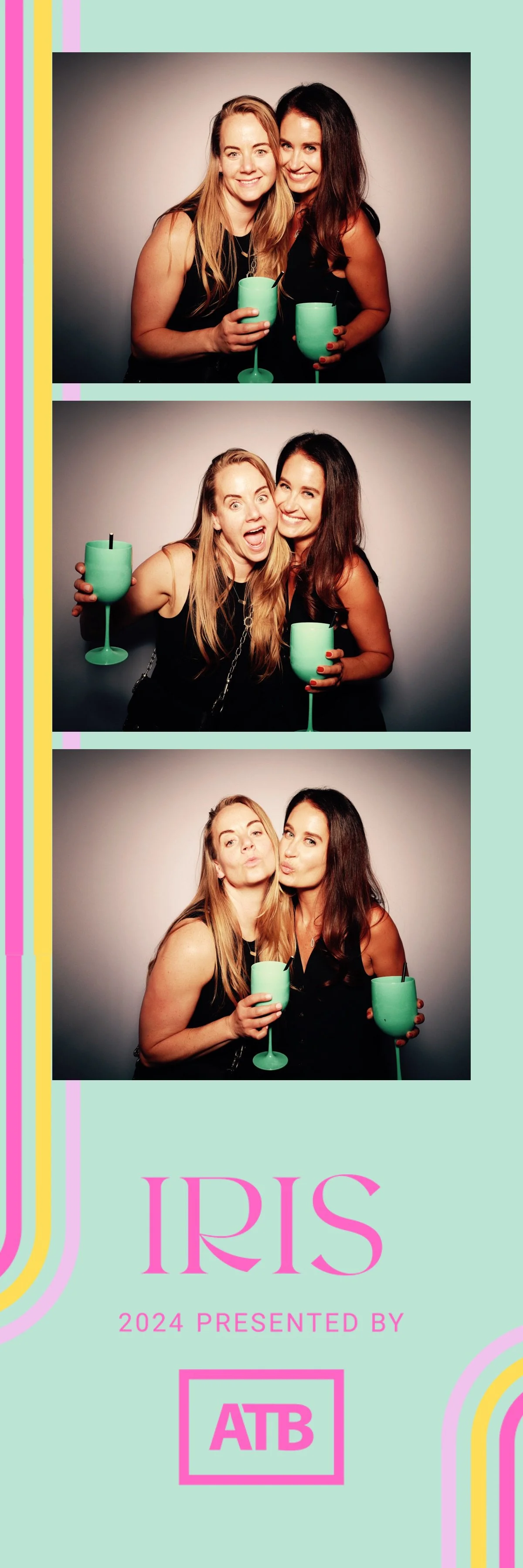 Photo booth strip with three pictures of two women celebrating, holding turquoise drinks. In the first image, they smile with their drinks. In the second, they make funny faces. In the third, they blow kisses. The strip has pastel rainbow stripes on 