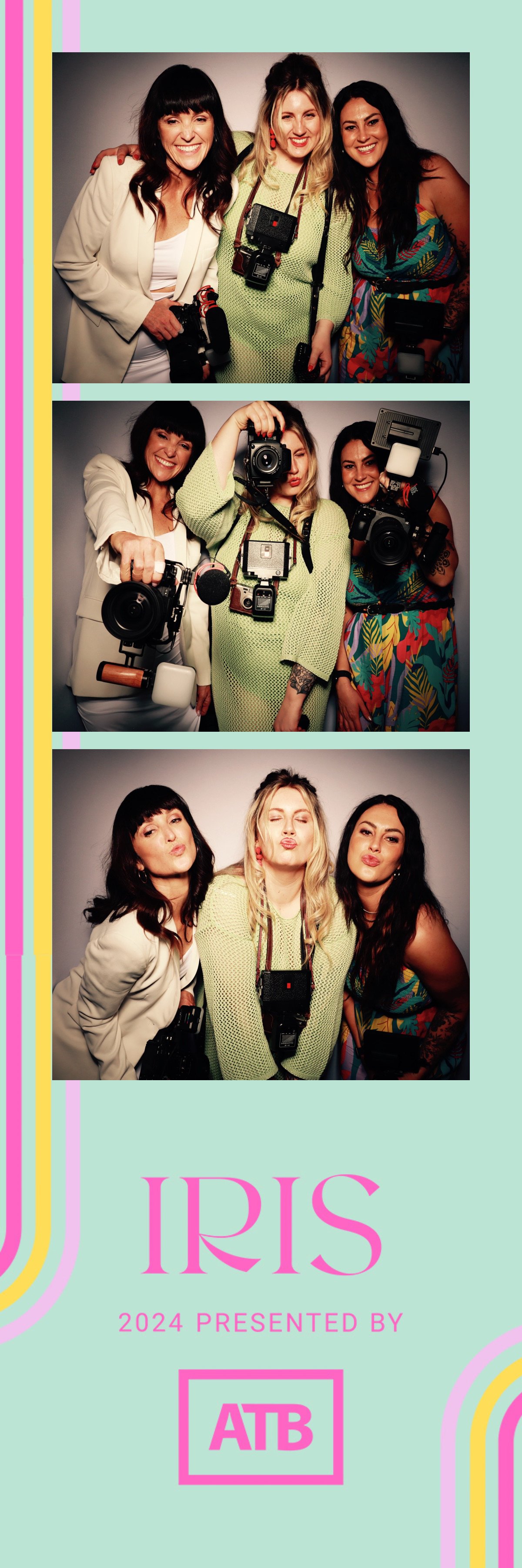 A group of three women posing together in a photo booth, showing different facial expressions. They are dressed in colorful and stylish outfits, and several of them have professional photography equipment hanging around their necks or in their hands.