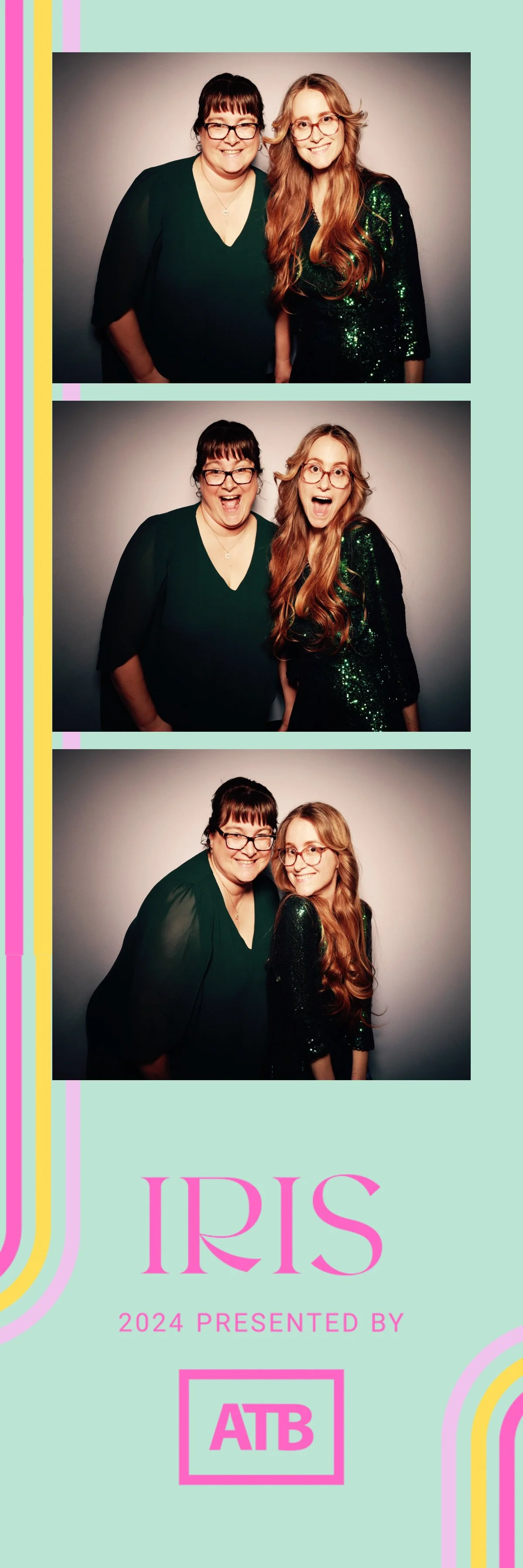 Three photo booth images of two women smiling and making expressive faces against a gray background. The women are wearing dark green outfits, one with glasses and long red hair, the other with short dark hair and glasses. The bottom of the image fea