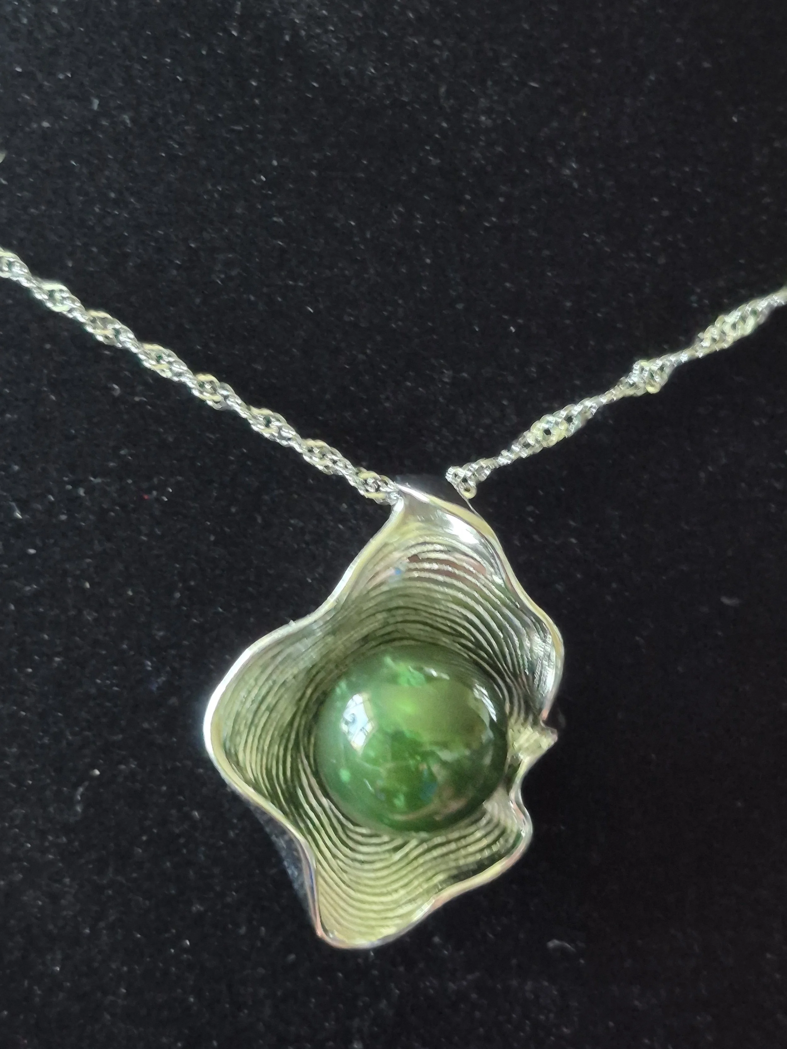 Canadian Nephrite Jade Oyster Shell Pendant Necklace On A Black Background