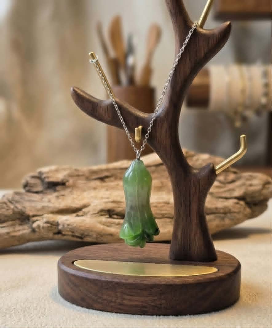 Jade Flower Bud Pendant On Display Rack.jpg