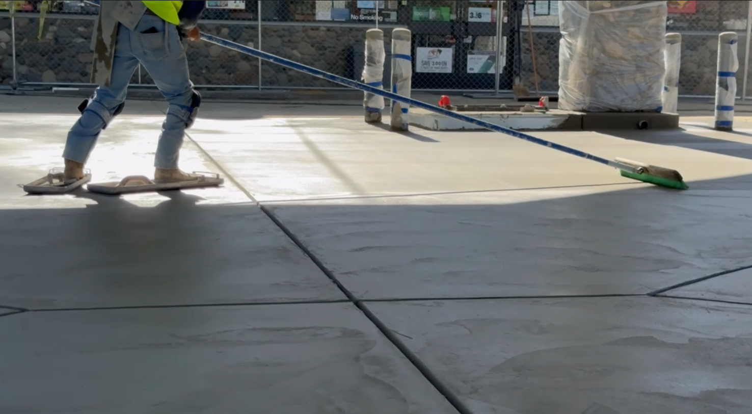 Concrete finisher using fresno tool on commercial flatwork Bay Area — Precision Concrete Engineering Inc.
