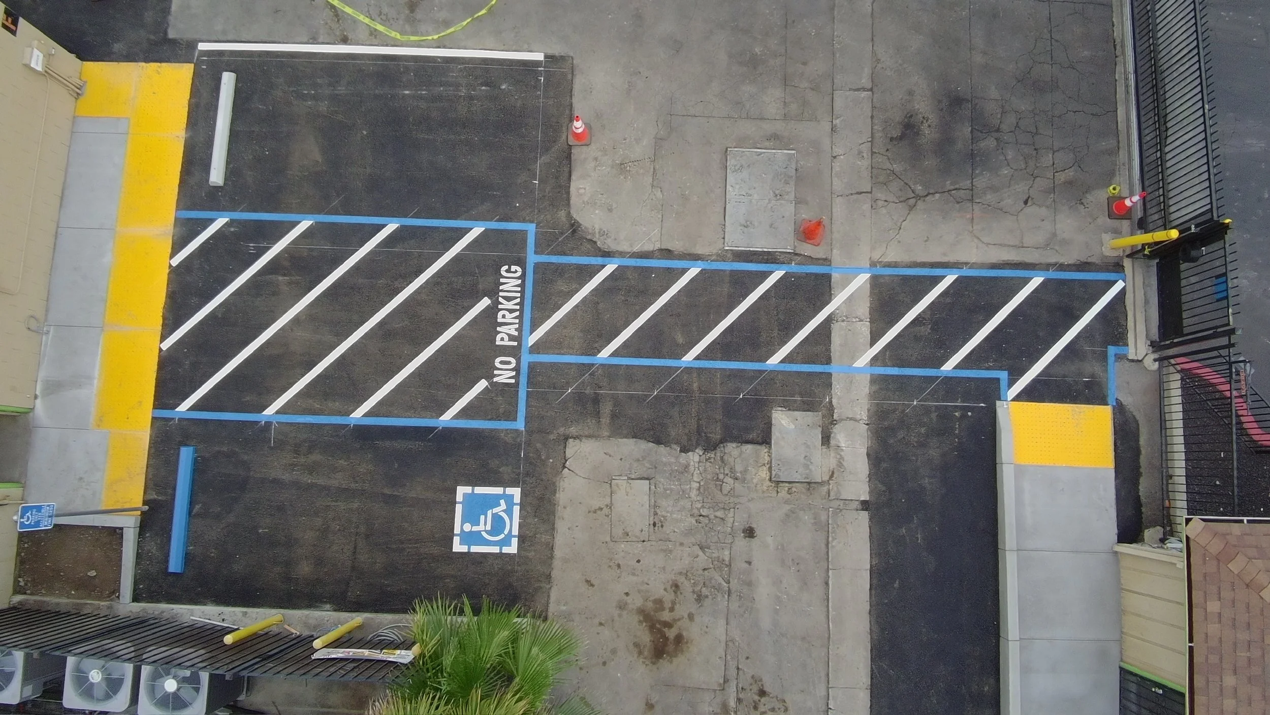 Aerial view completed commercial parking lot with ADA striping and accessible pathways Bay Area — Precision Concrete Engineering Inc.