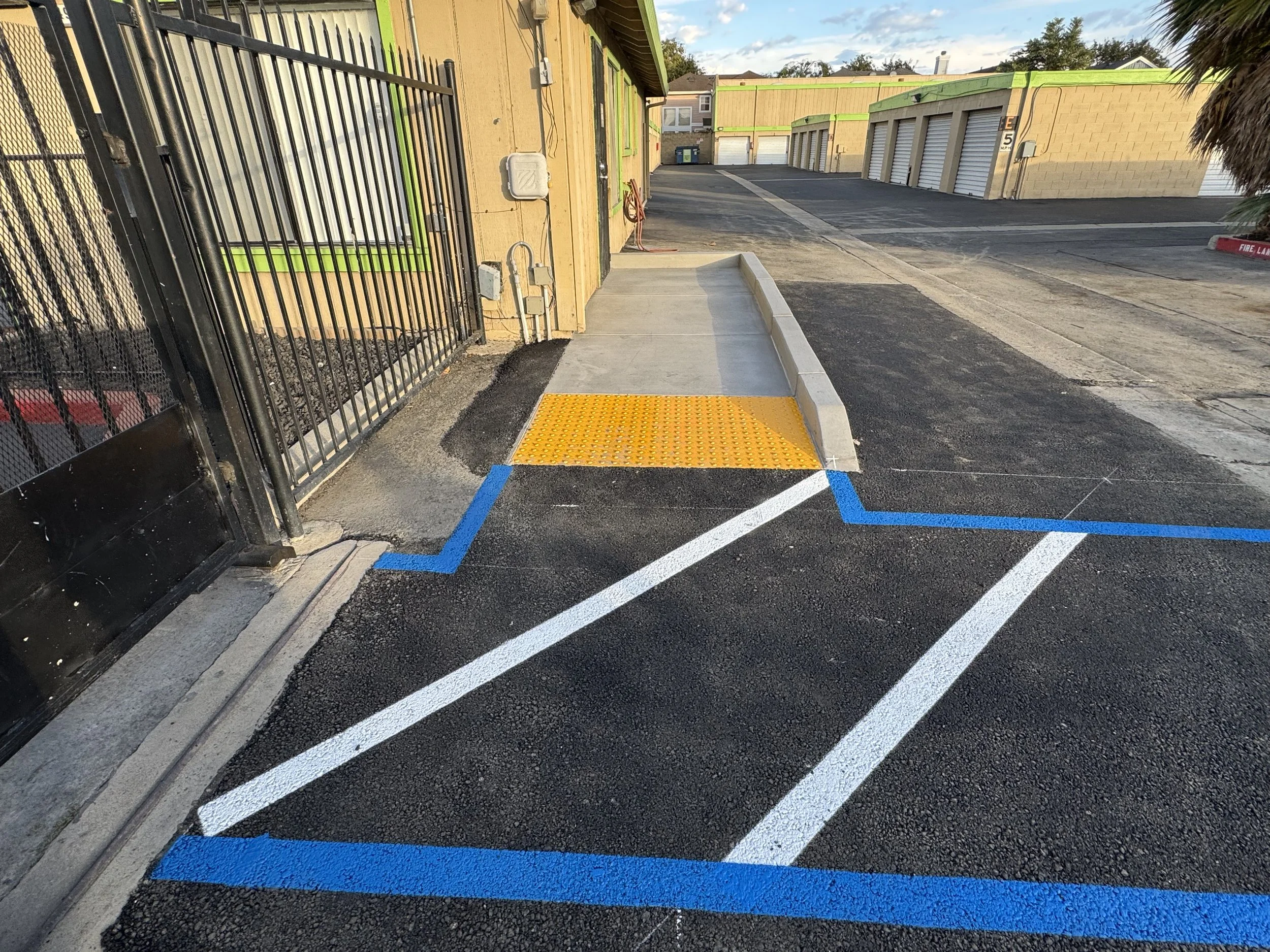 After — completed commercial parking lot with ADA ramp and blue striping Bay Area — Precision Concrete Engineering Inc.