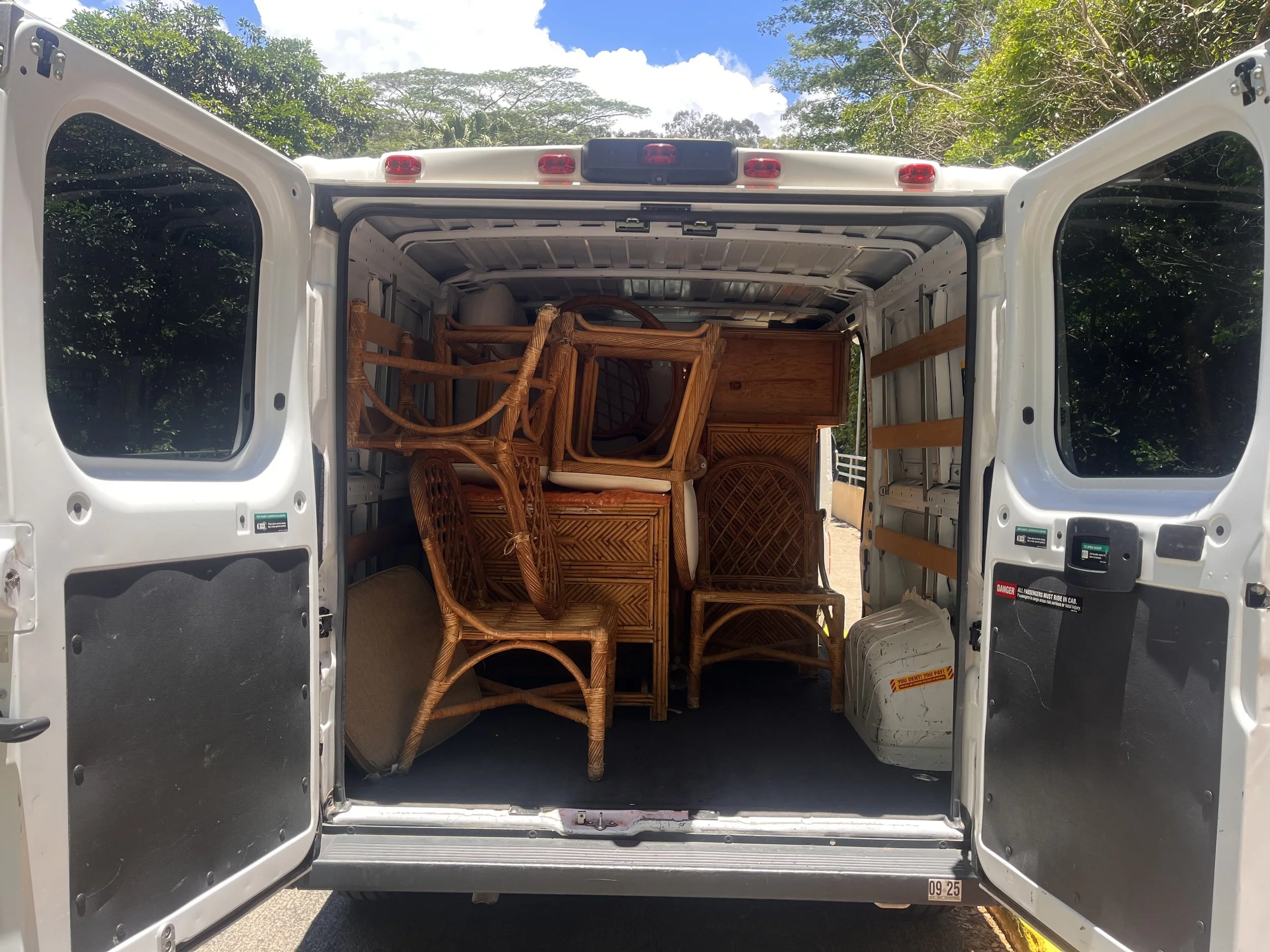 Furniture packed in a cargo van during a condo cleanout for a property manager
