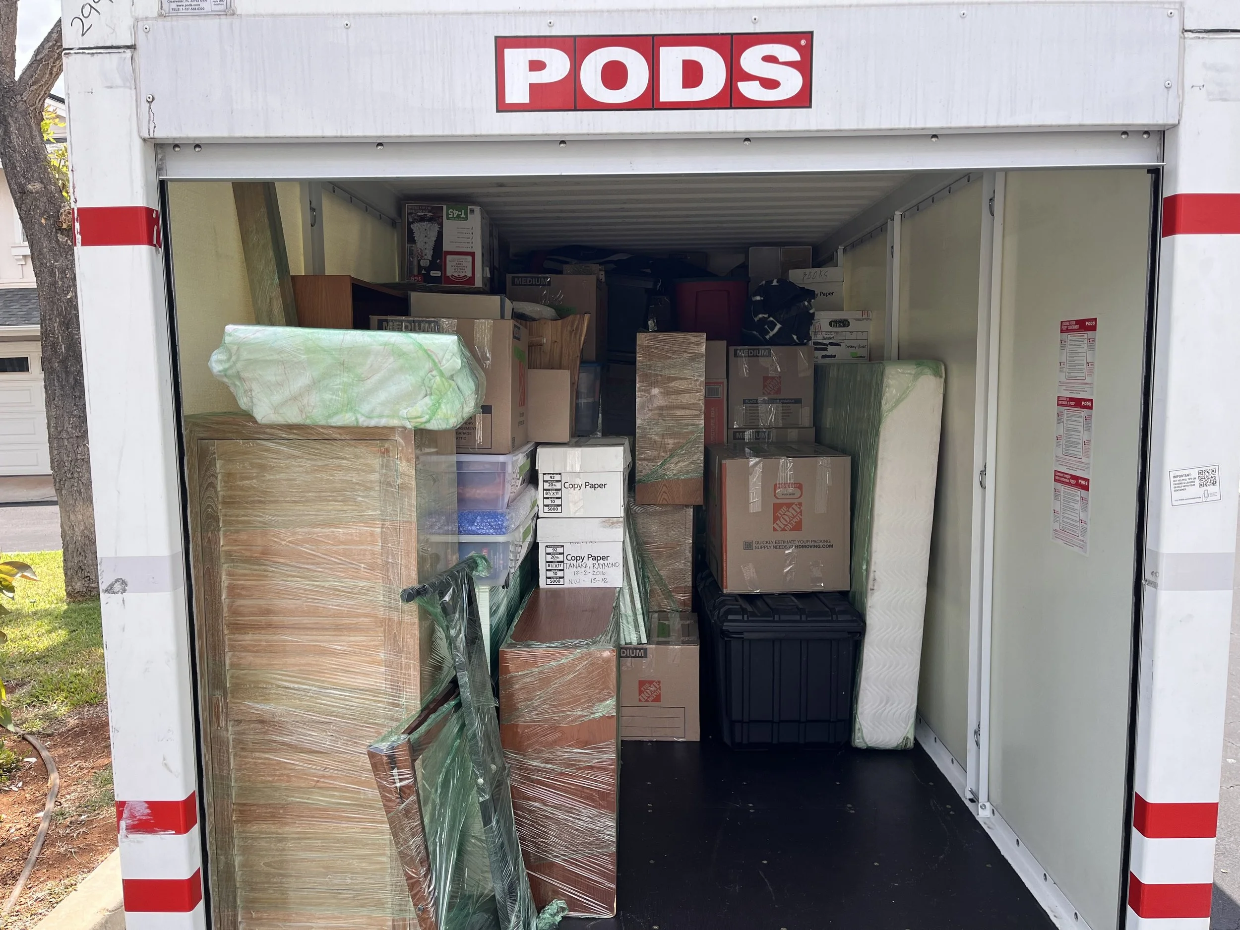 Loaded PODS portable storage container being loaded on Oahu