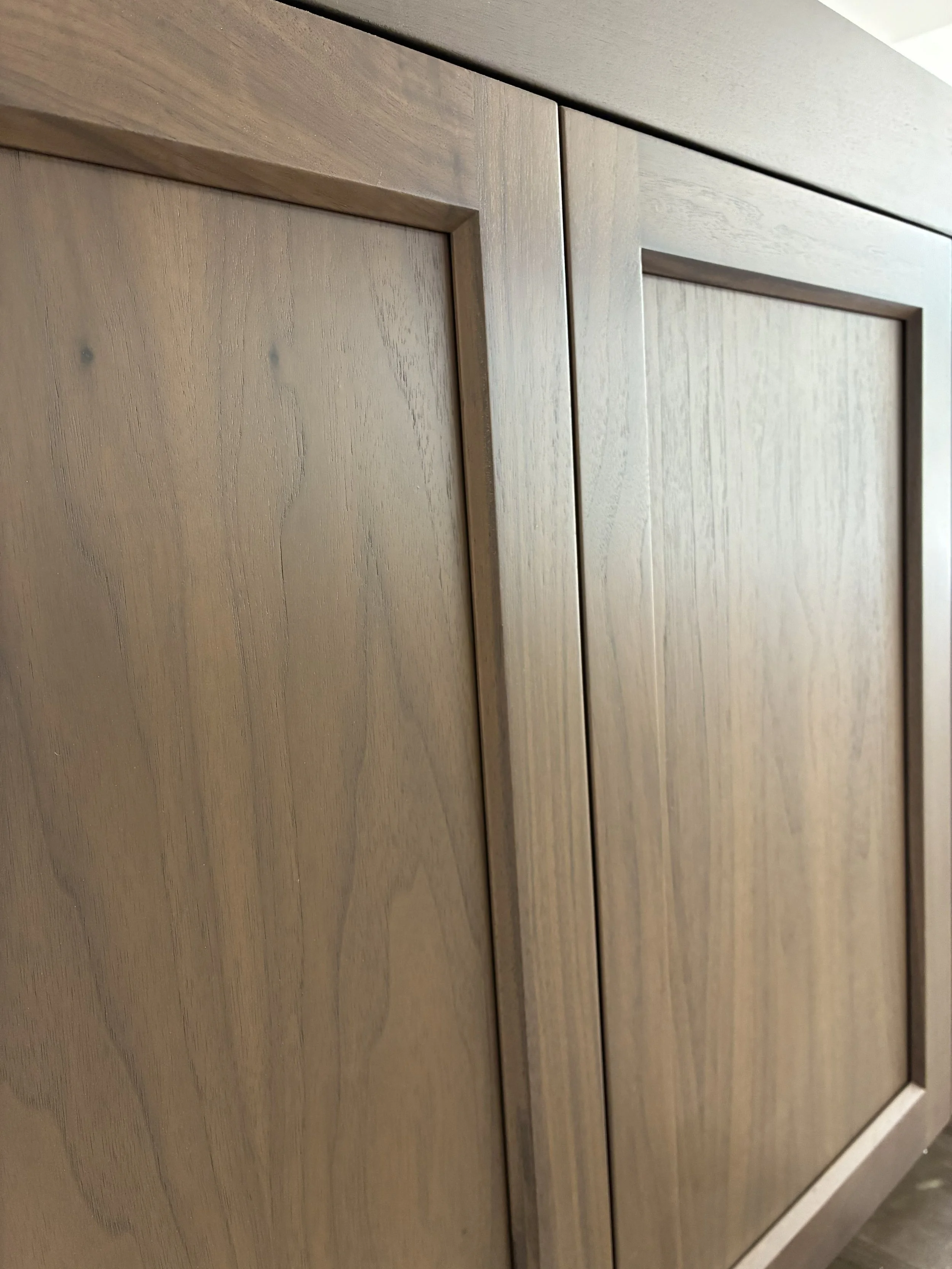 Close-up of wooden cabinet doors with a natural wood finish.