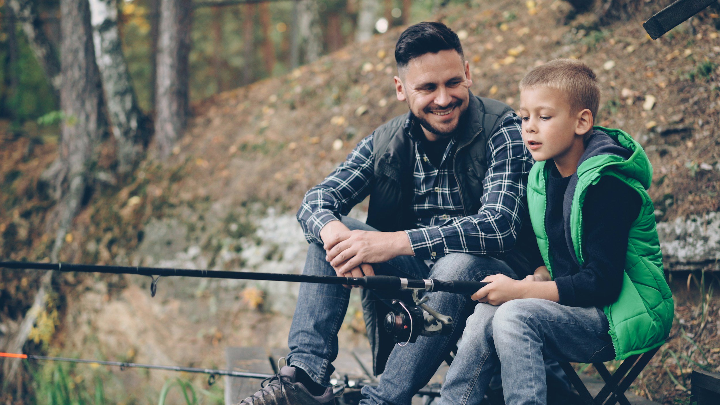 Photo of : Father and Autistic Son fishing and communicating.