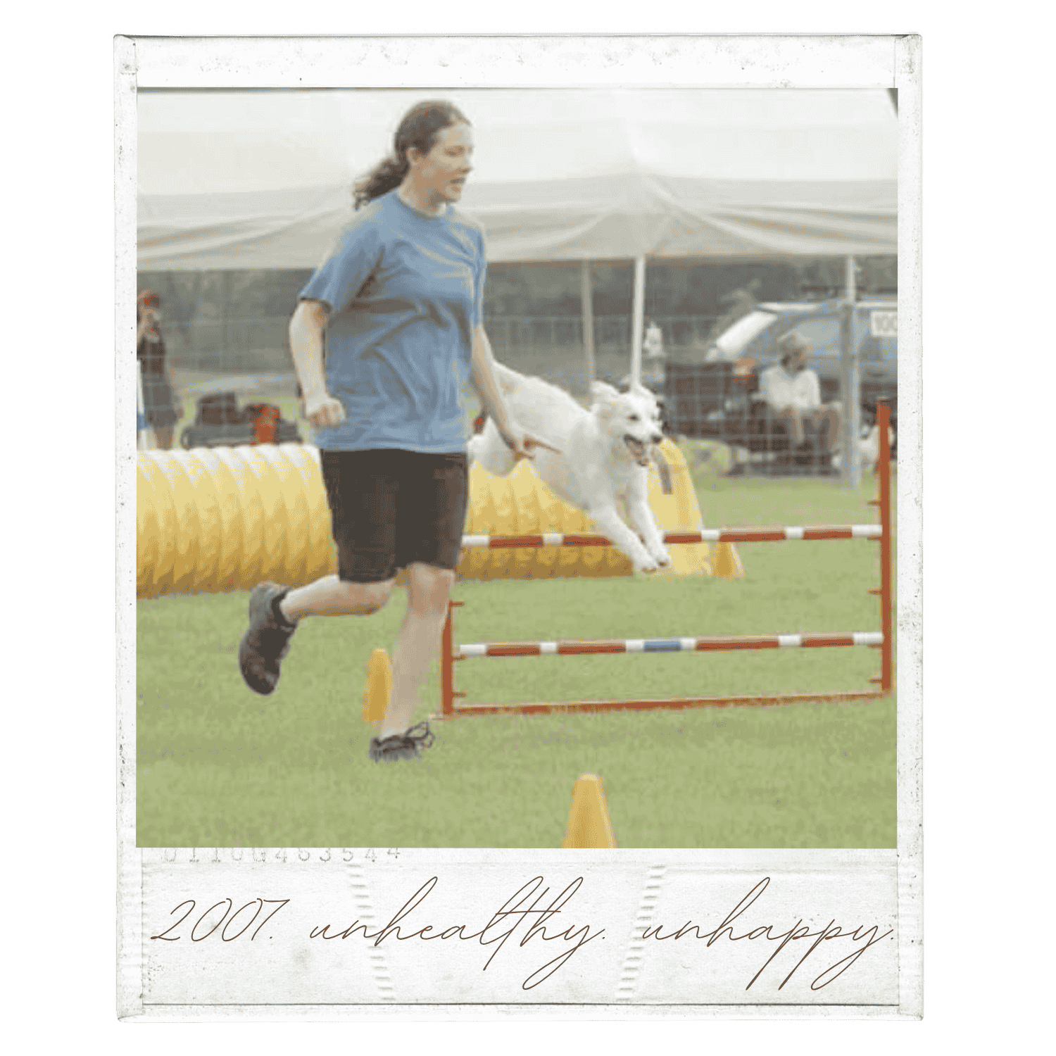 A woman and a dog participating in a dog agility competition, jumping over a hurdle on a grassy field with other agility equipment and a tent in the background.