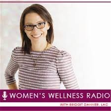 Smiling woman with glasses wearing a striped shirt, promoting Women's Wellness Radio with Brigid Dainler, LAC.