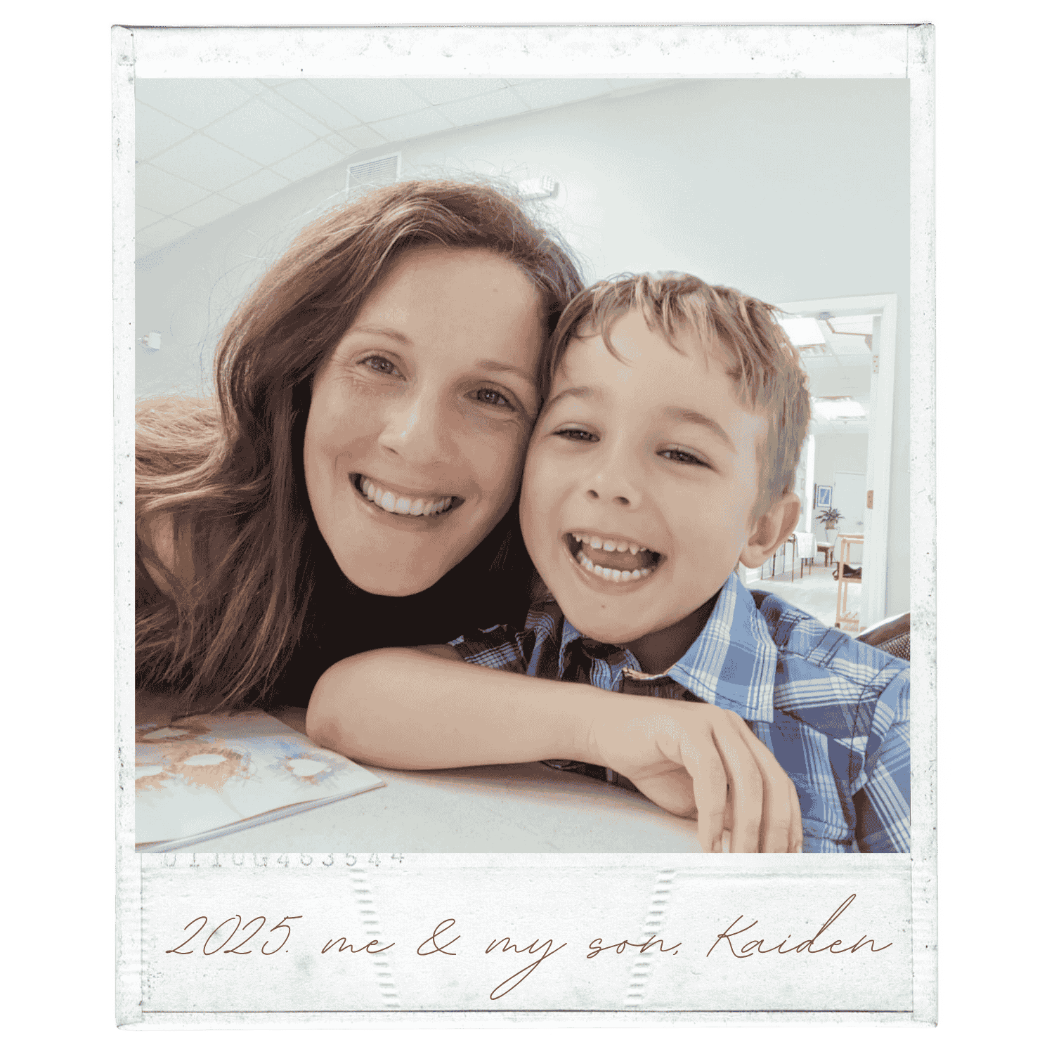 A smiling woman and young boy with light brown hair, close together indoors, with the woman leaning on a table and the boy resting his arm on it. The background shows a room with white walls and ceiling, and a window. The photo has a vintage style with handwritten text at the bottom that reads, "2025. me & my son, Kaiden."