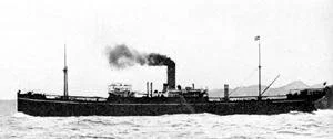 A black and white photo of an early 20th-century steamship with smoke coming from its smokestack, sailing on the water with smoke or clouds in the sky.