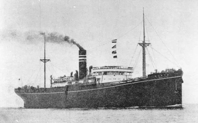 Black and white historic photograph of an early 20th-century steamship with smoke coming from its chimney, sailing on open water.