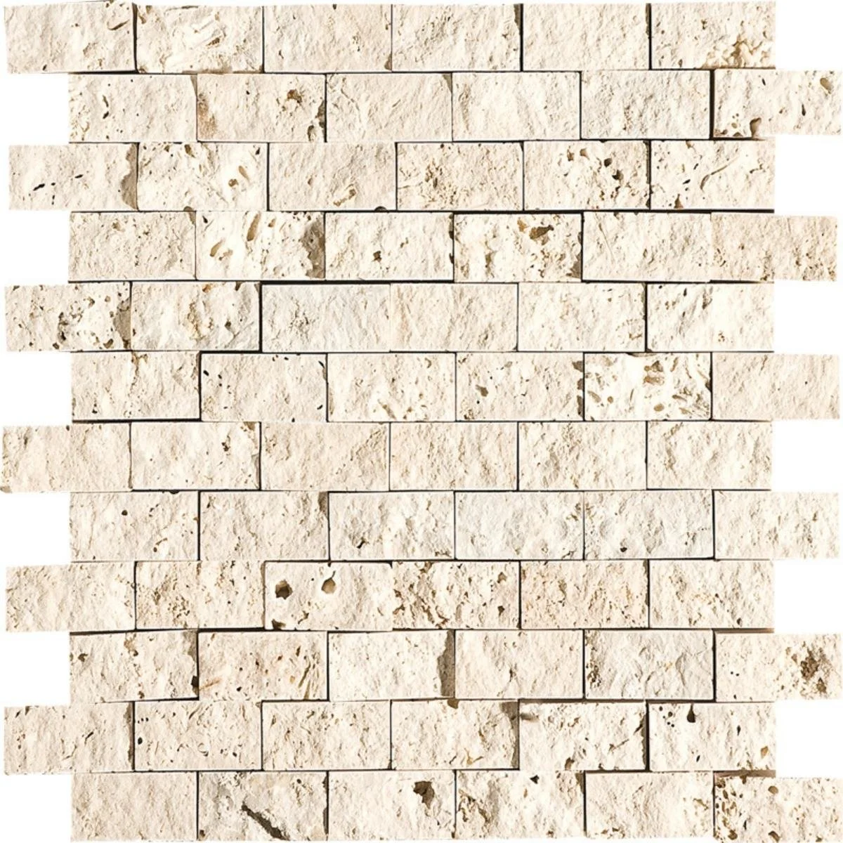 A wall made of rectangular cream-colored stone bricks with a rough texture and visible irregularities.