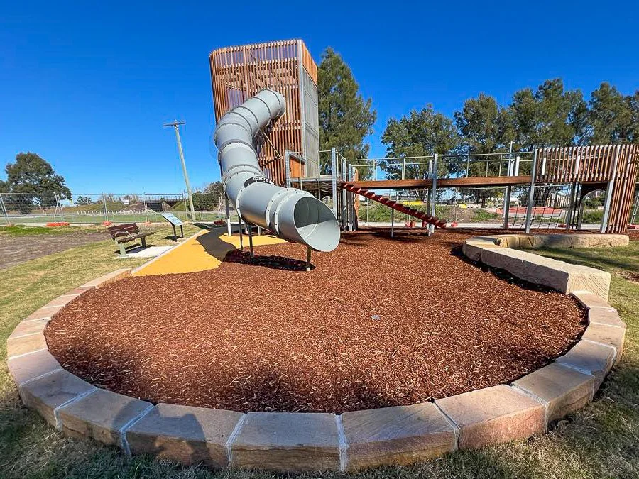 Commercial playground landscaping in maitland, sandstone blocks and seats.