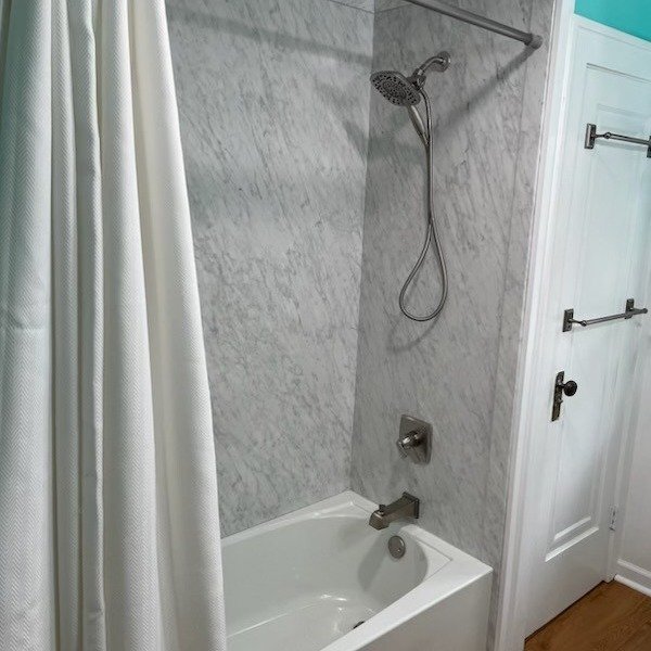 Bathroom remodel with marble-look shower surround, updated fixtures, and soaking tub – Tampa FL