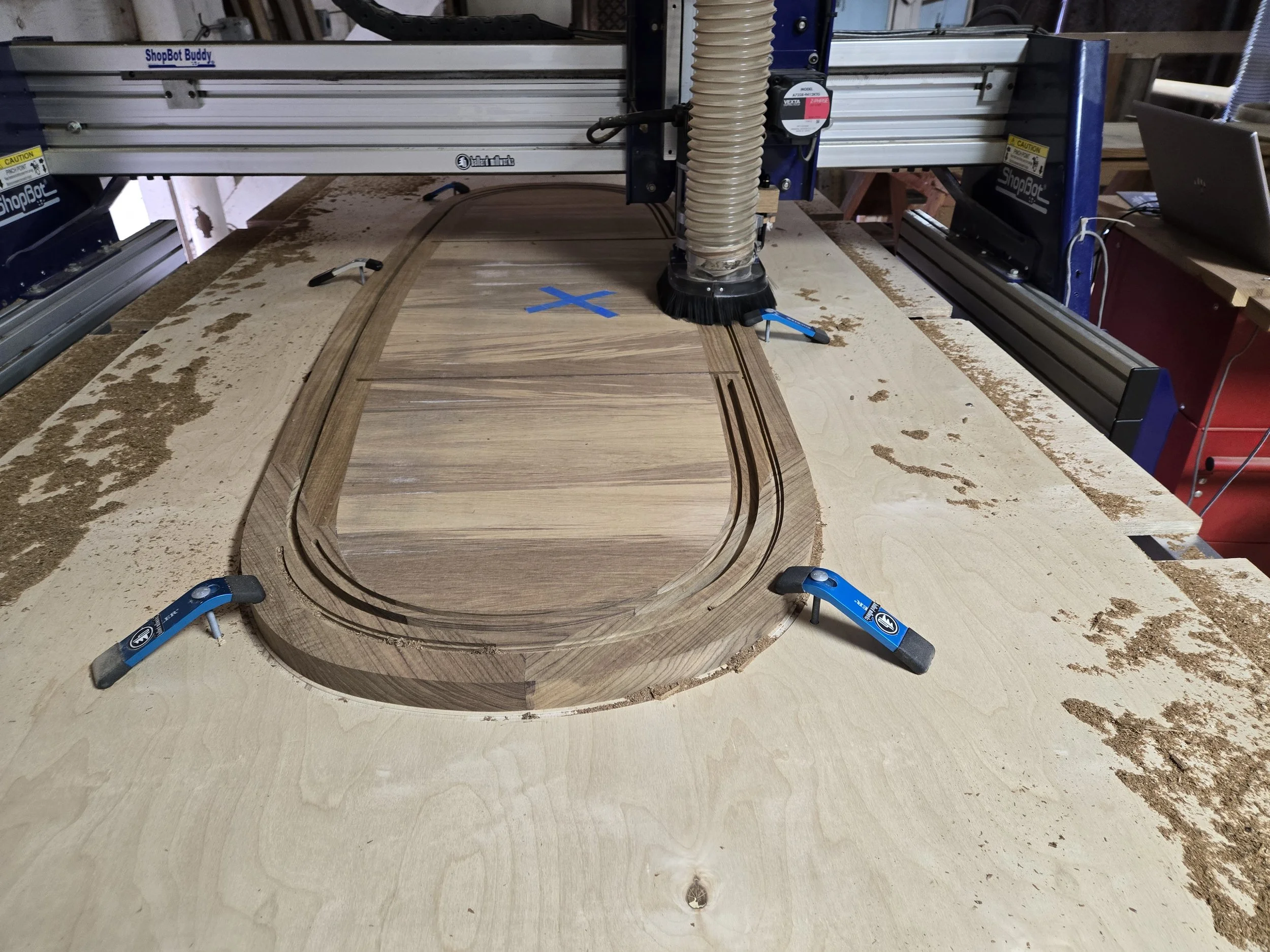 Teak tabletop on CNC router with channels cut for tambour door