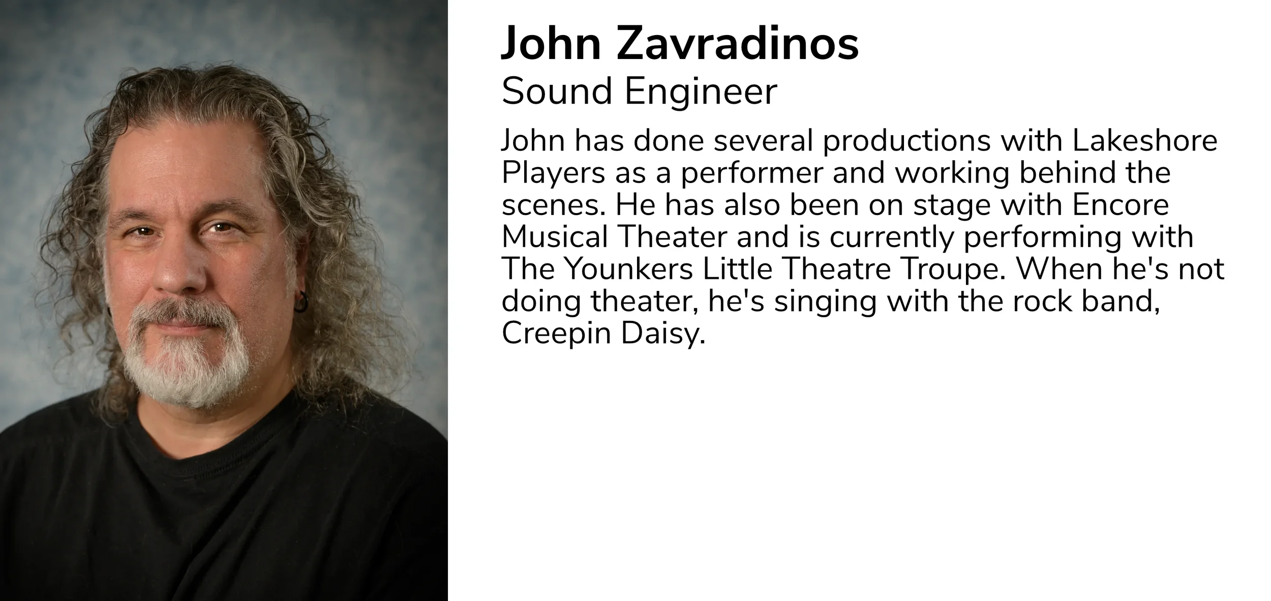 Portrait of John Zavradinos, a sound engineer with gray curly hair, a beard, and mustache, wearing a black shirt, against a gray background.