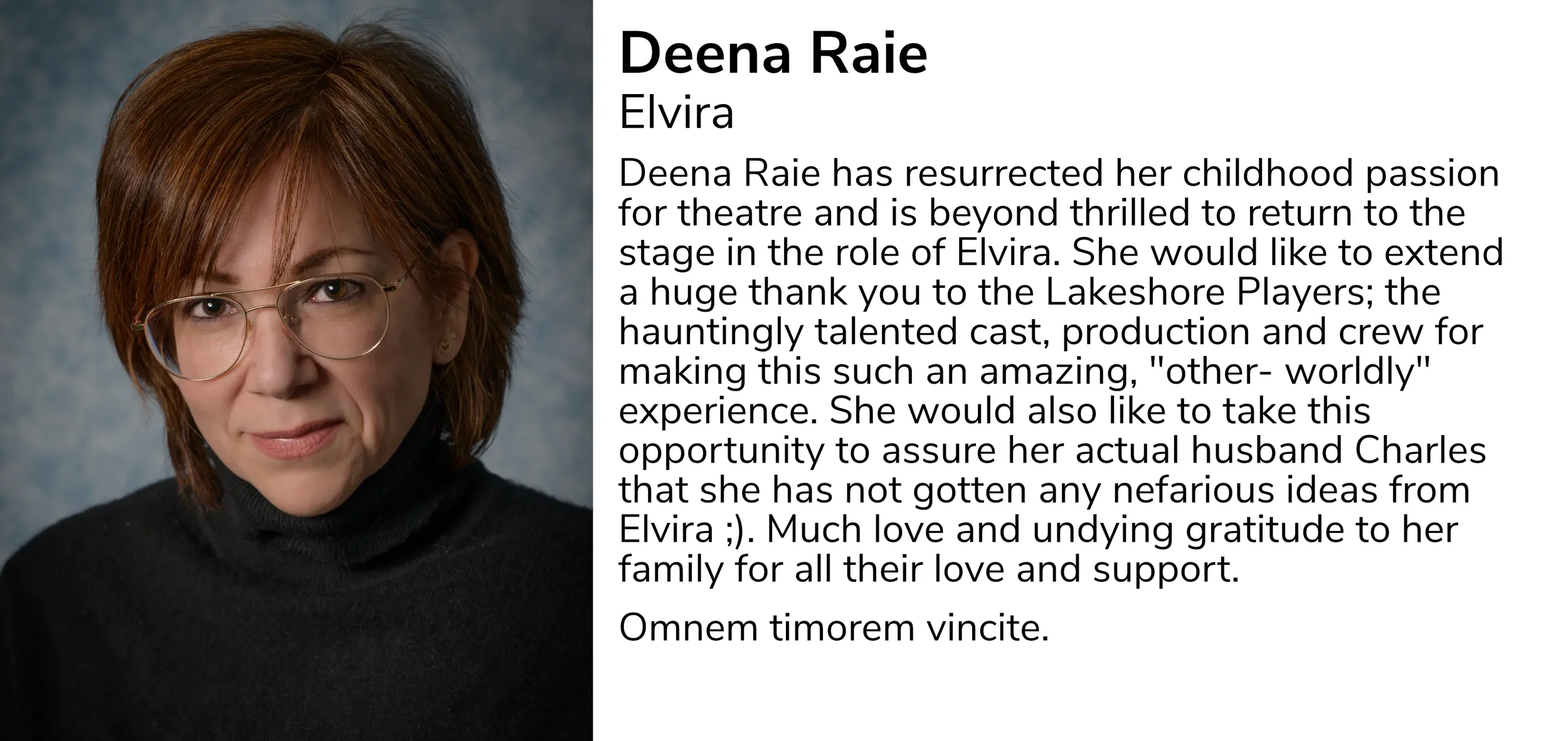 A headshot of a woman with short, reddish-brown hair, wearing glasses and a black turtleneck sweater.