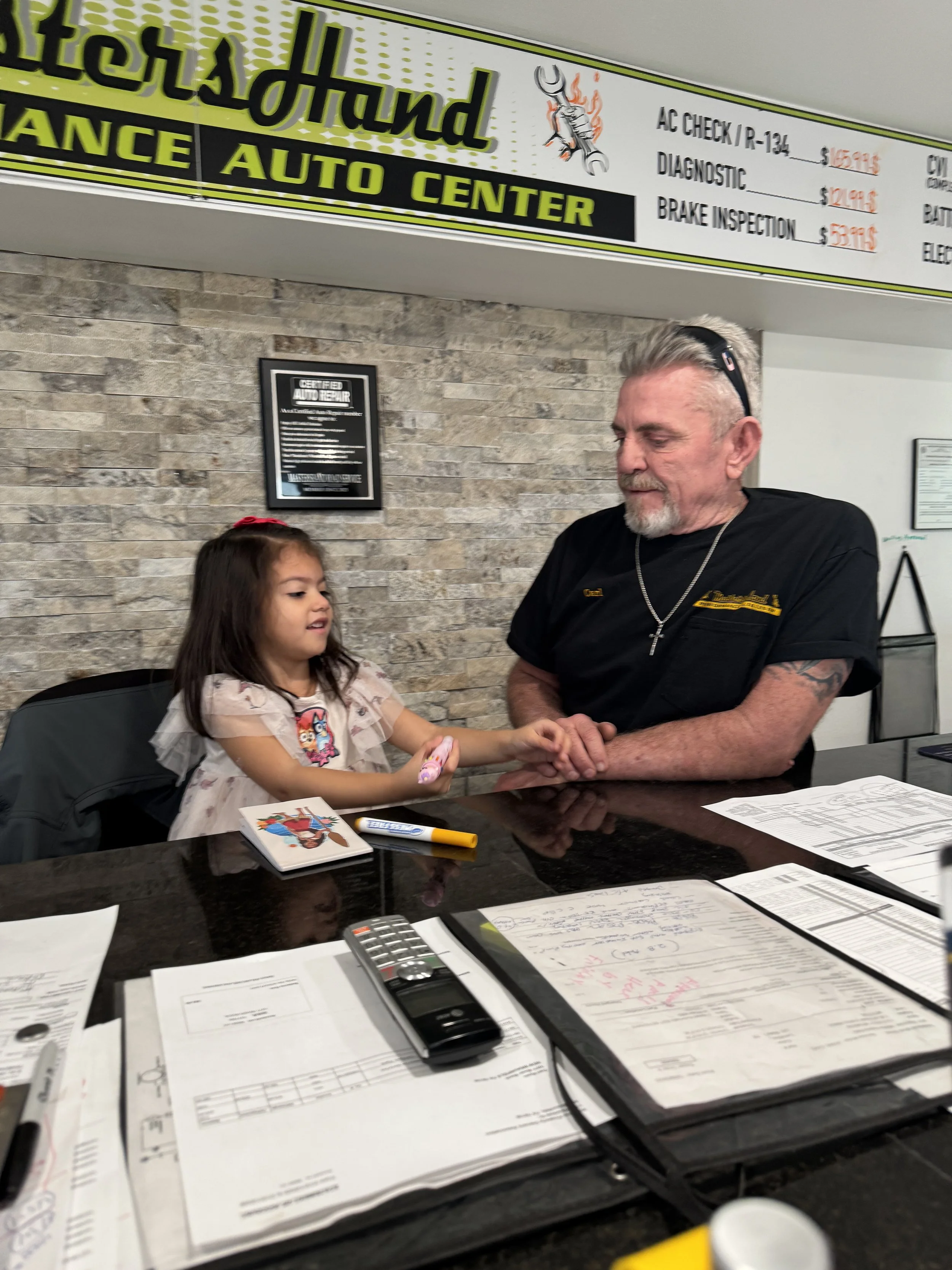 Farrah managing the shop with Grandpa Carl.