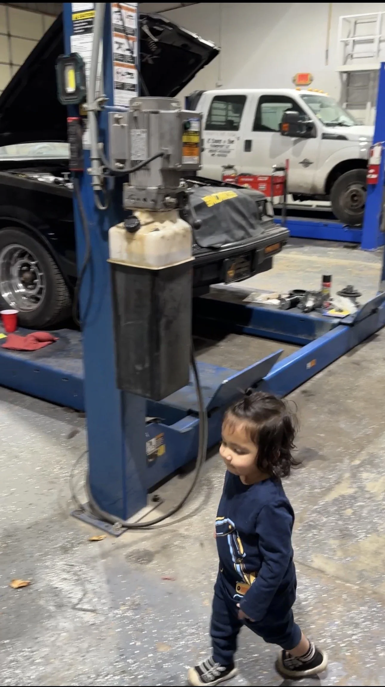 Elio walking in the shop checking on things.