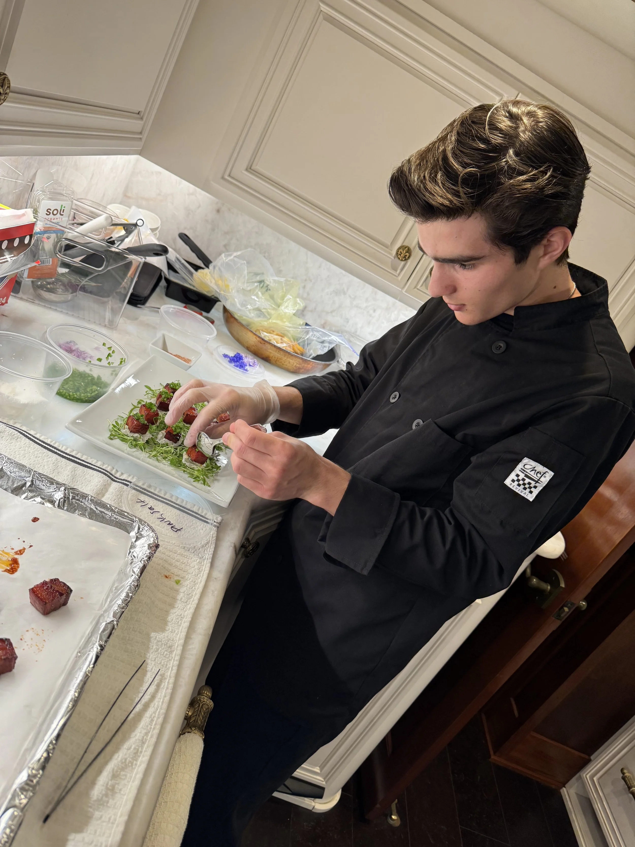 Chef Callahan garnishing an Amuse Bouche on a yacht.