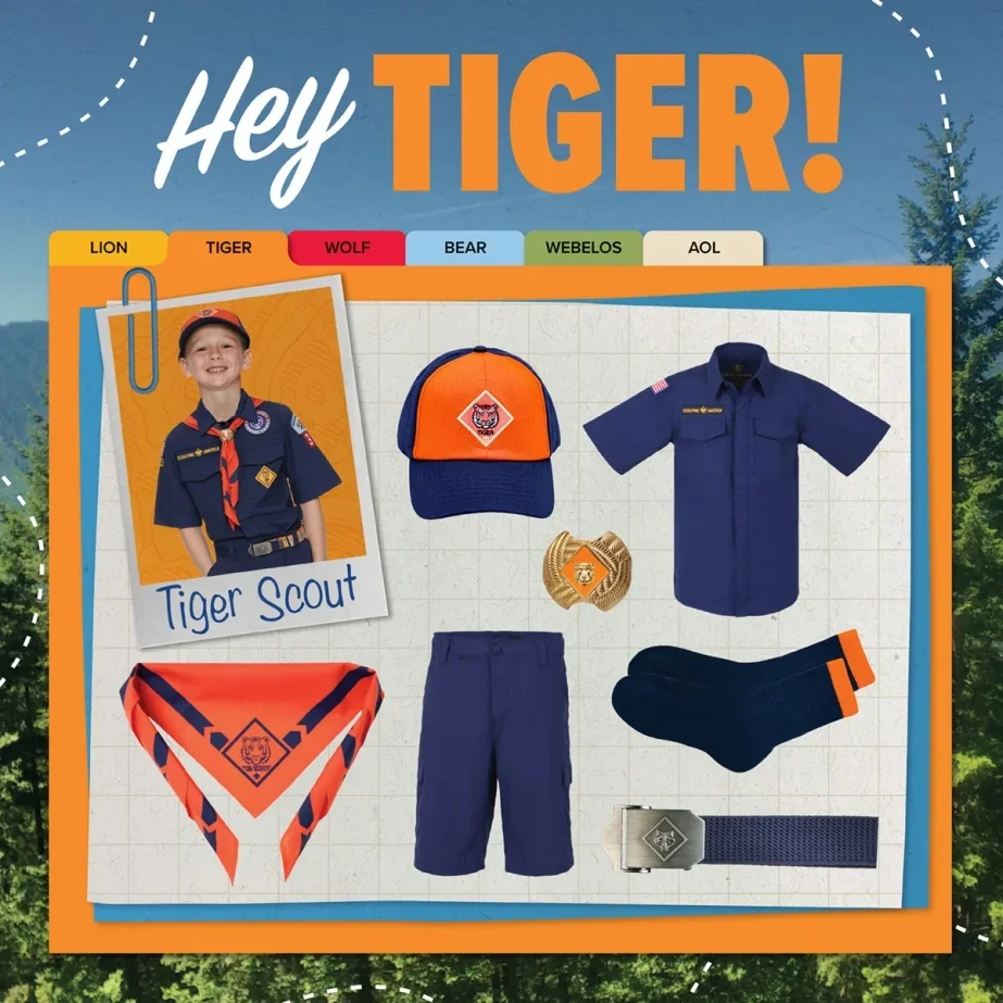 Boy in Boy Scout uniform with cap, badge, neckerchief, and shorts, surrounded by scout gear including a cap, shirt, neckerchief, badge, socks, belt, and shorts, with a background of trees and a promotional graphic reading "Hey TIGER!"
