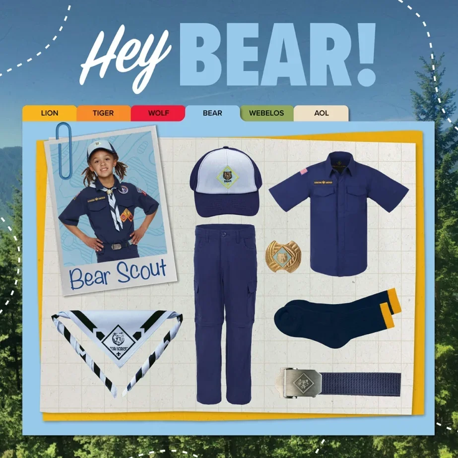 A Girl Scout uniform display including a girl in a navy blue Scout uniform with a neckerchief, cap, pants, belt, badge, and socks. The display features a hat, shirt, pants, socks, badge, and belt, with labels for different animal themes: Lion, Tiger, Wolf, Bear, Webelos, and AOL.