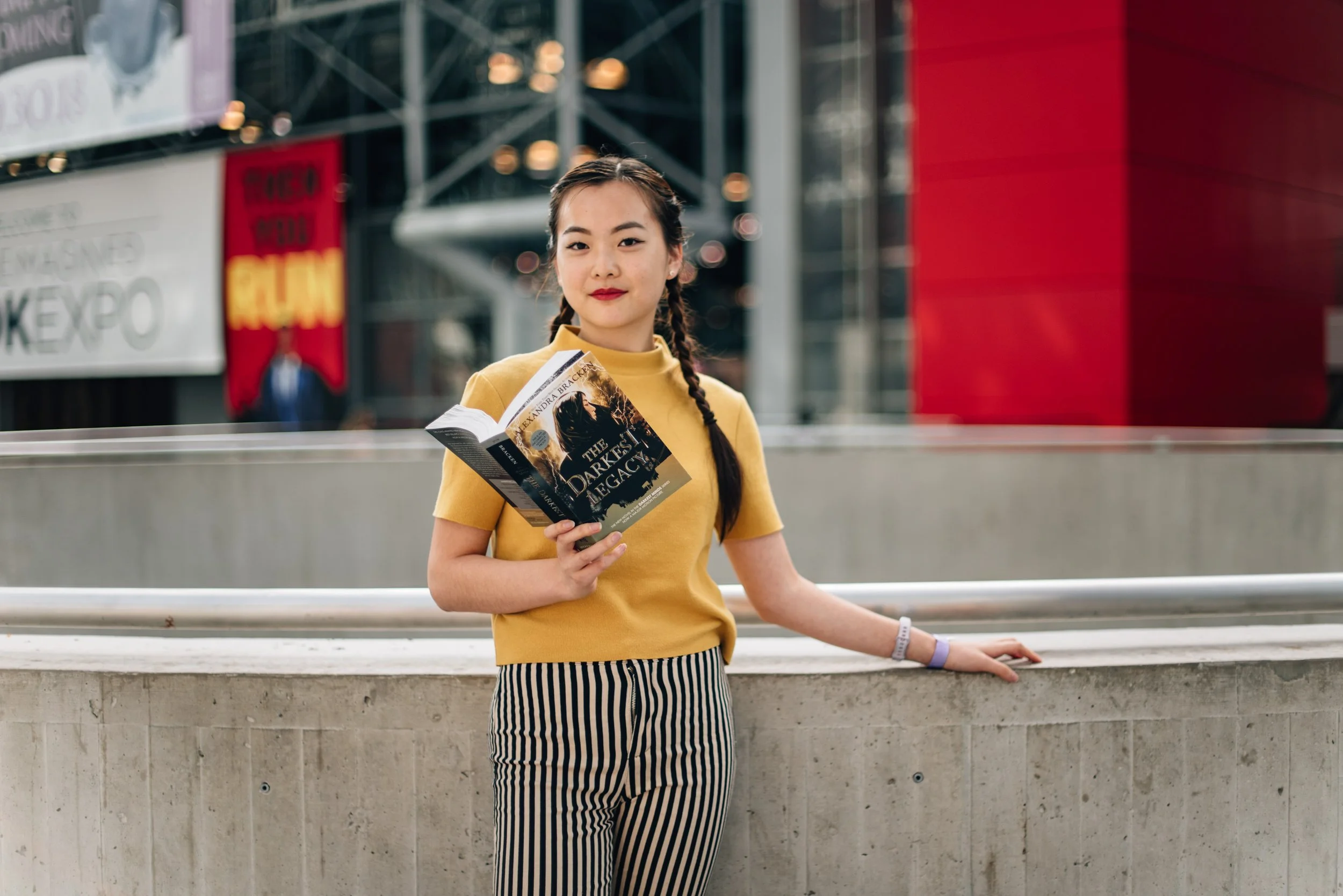BT137-asian-woman-yellow-top-with-book.jpg