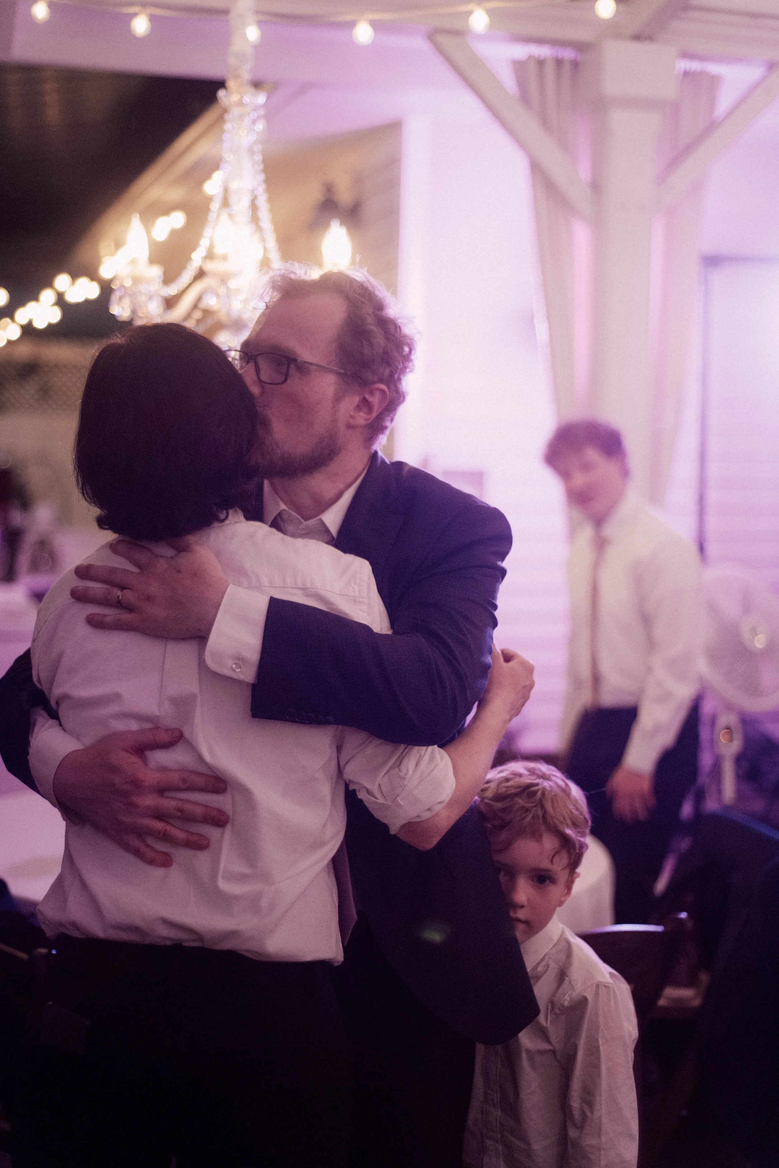HRD86-man-hugging-bride-with-small-child.jpg