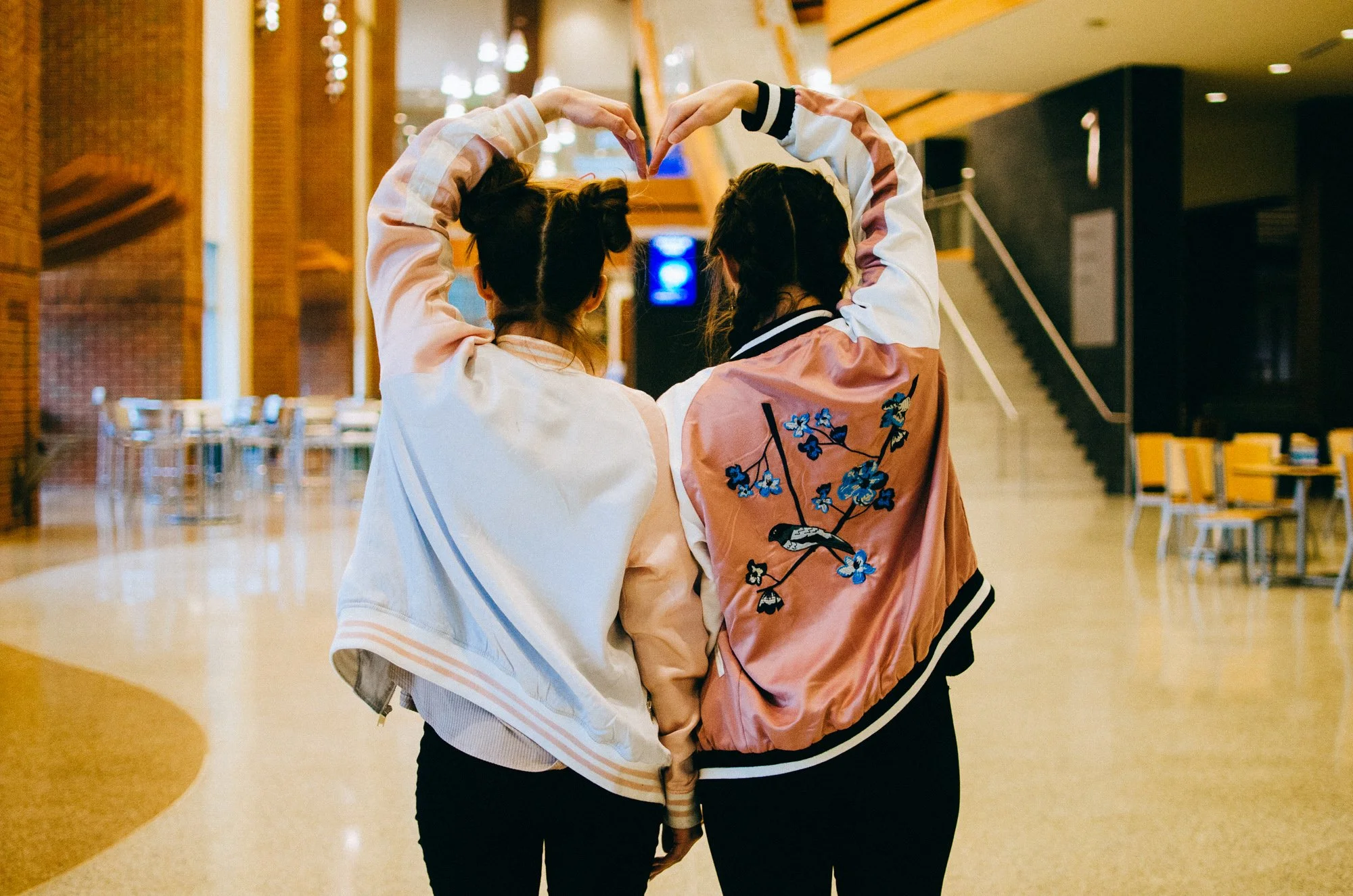BT142-two-women-making-a-heart-with-arms.jpg