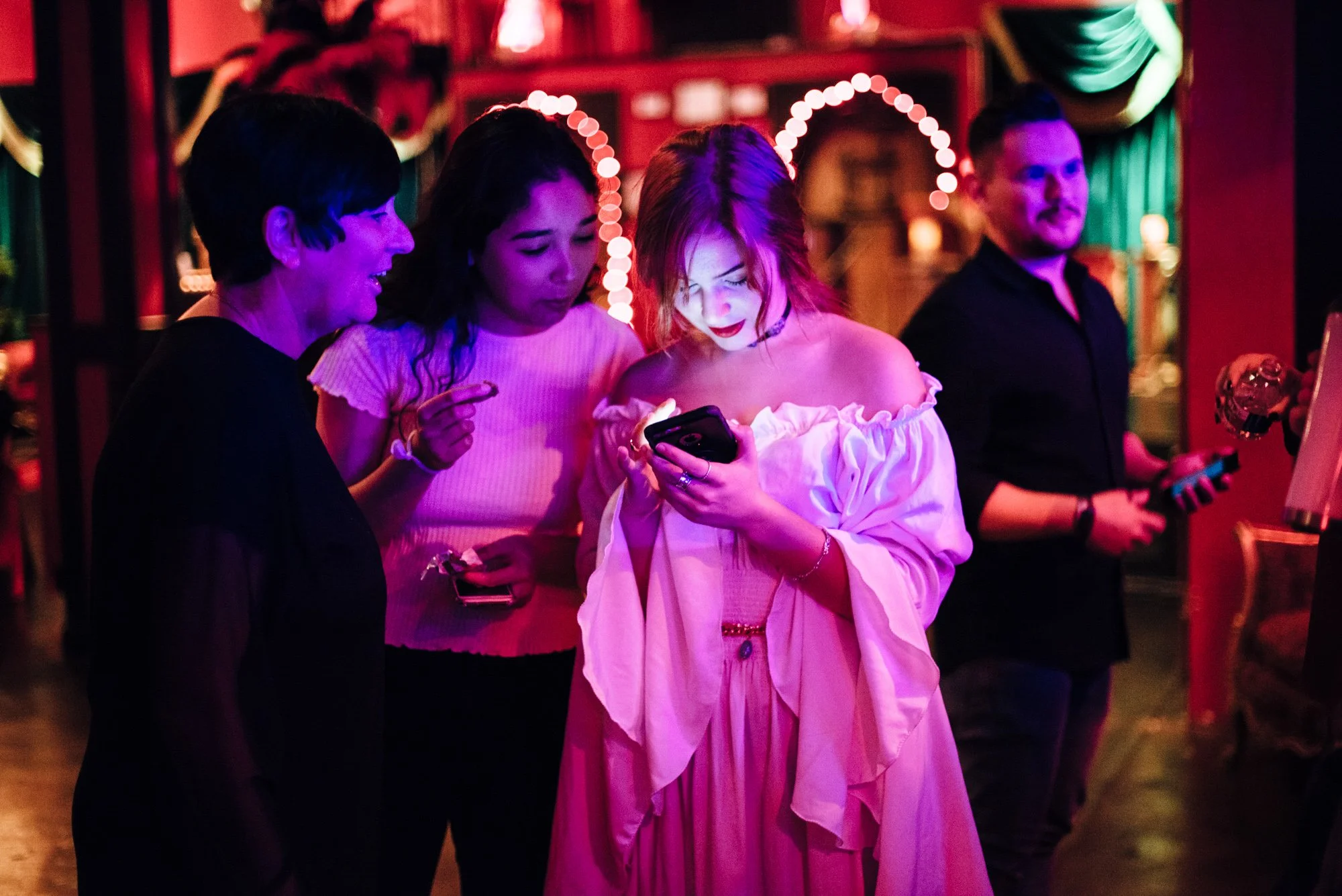 BT175-women-looking-at-phone-dark-lighting.jpg