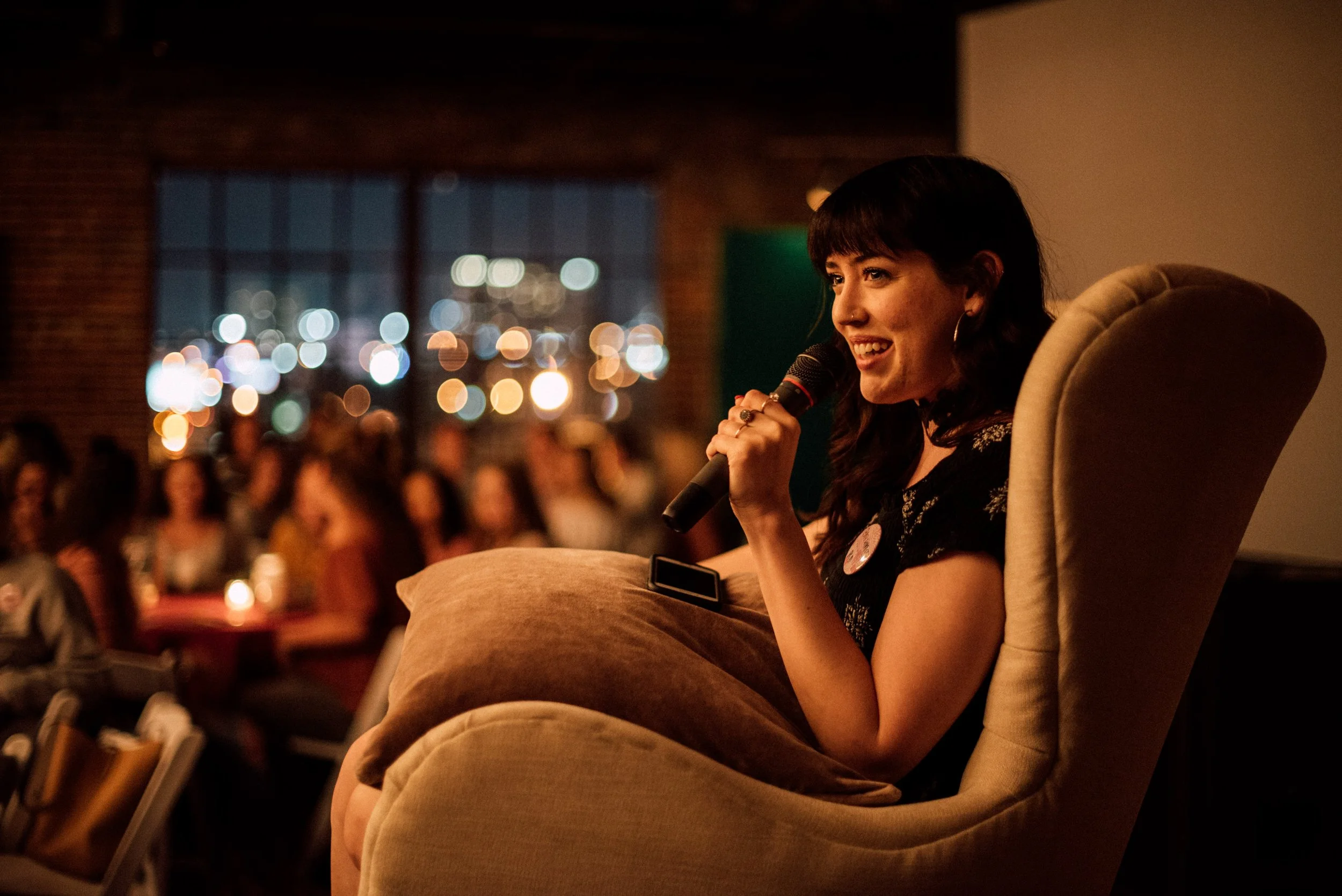 d220-woman-microphone-speaking-in-chair.jpg