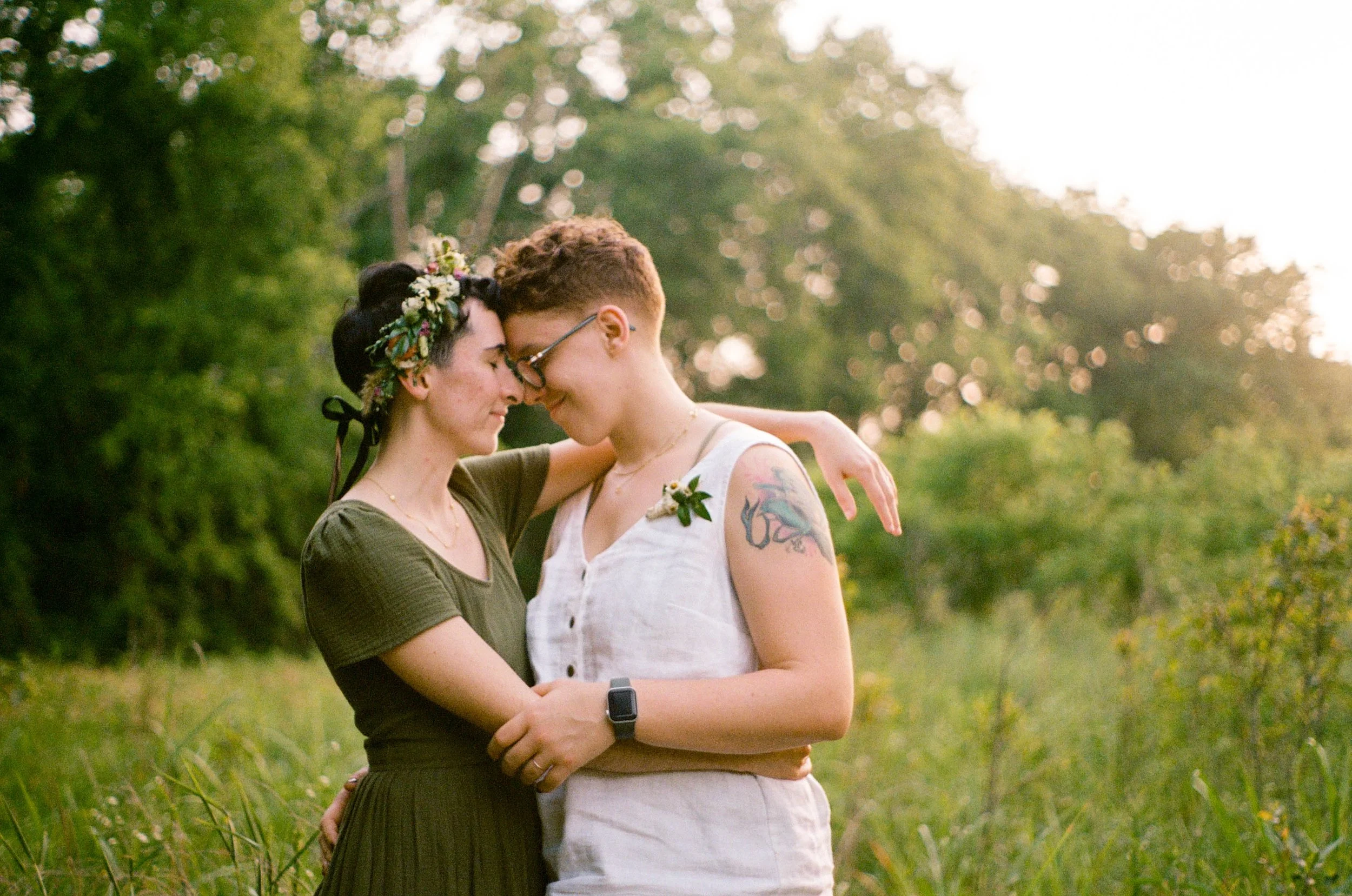 REW91-queer-couple-foreheads-together-sunset.jpg