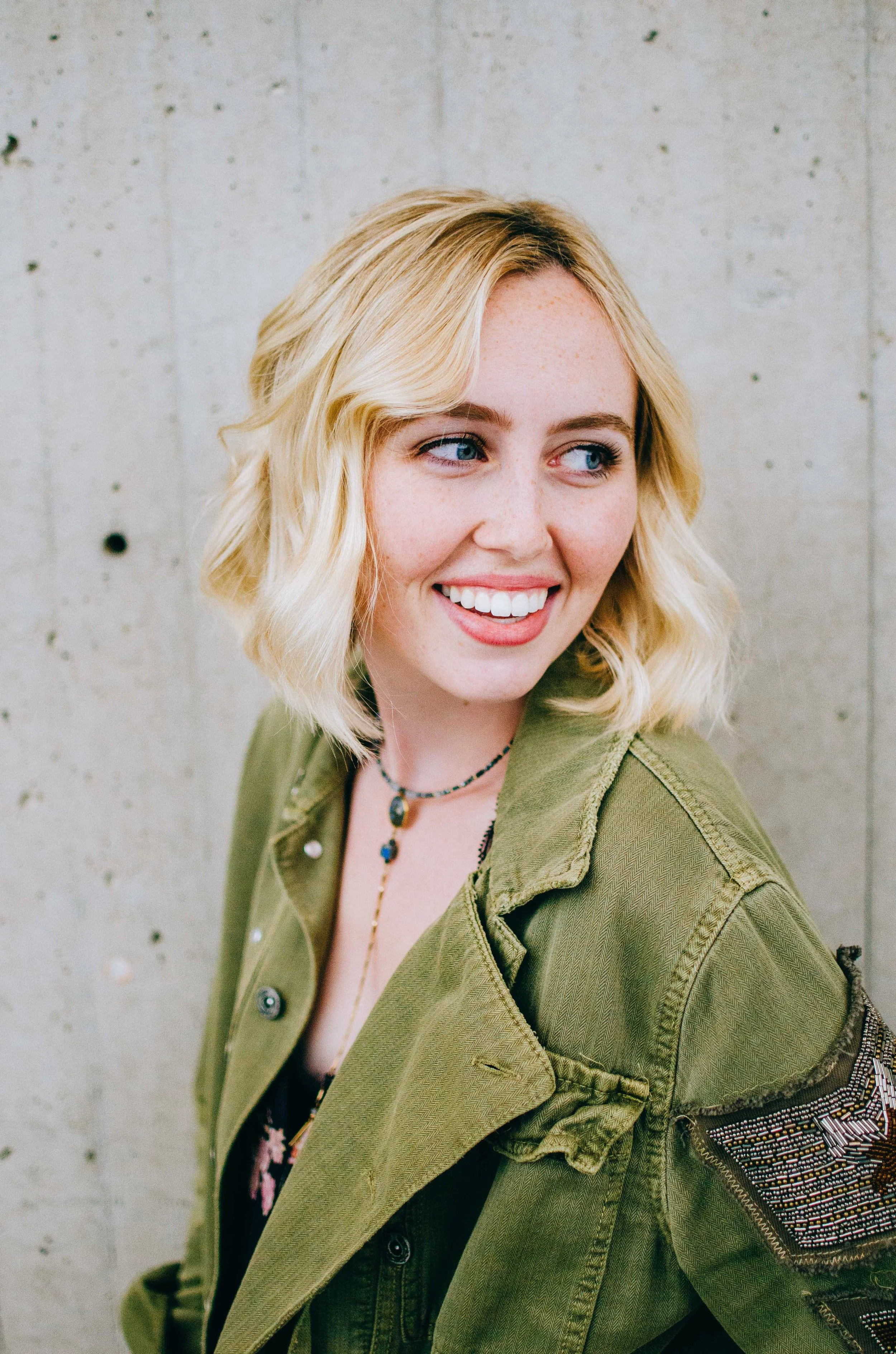 BT221-blonde-woman-green-jacket-smiling-javits.jpg