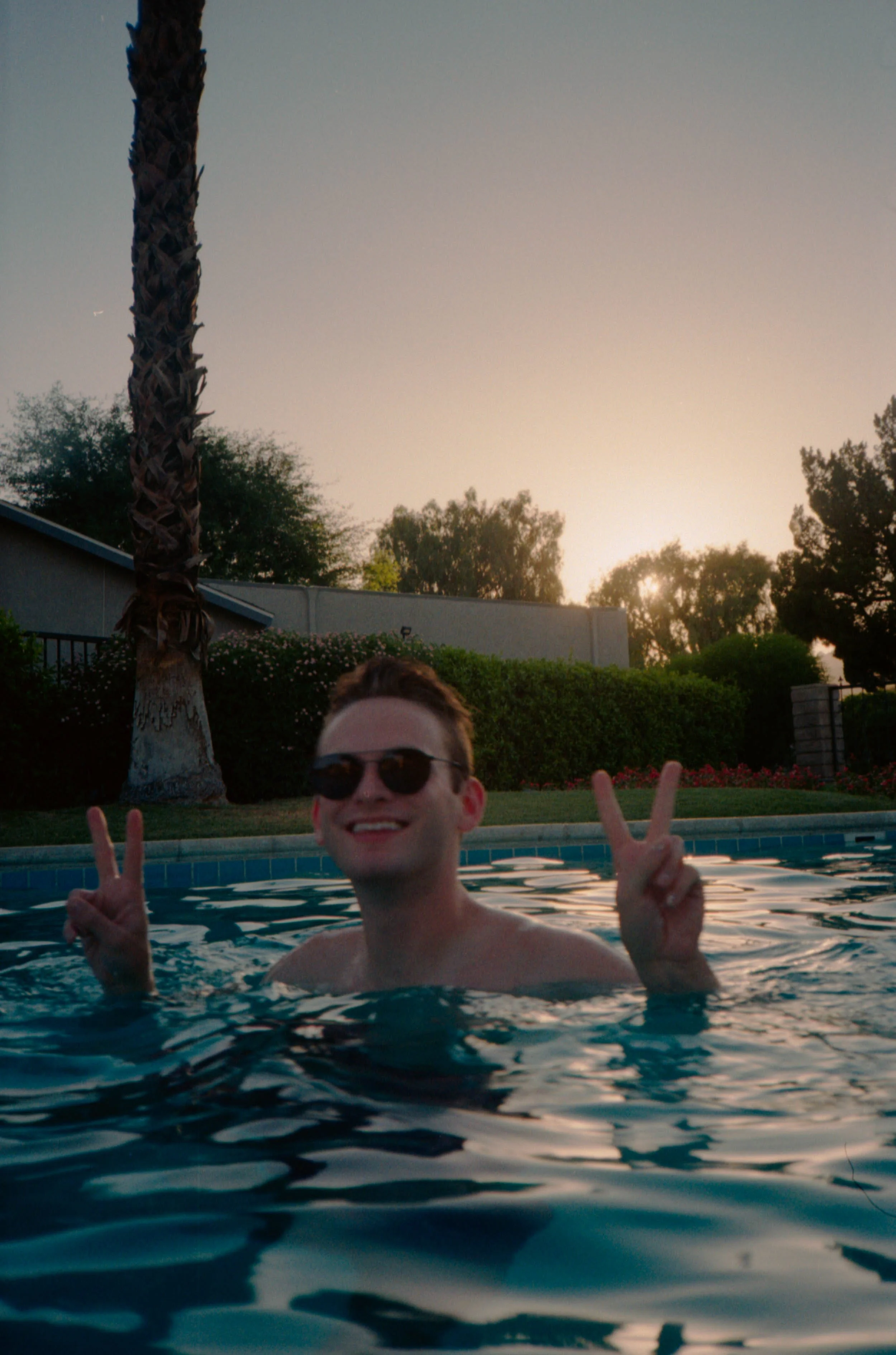 BT69-man-in-pool-peace-signs.jpg